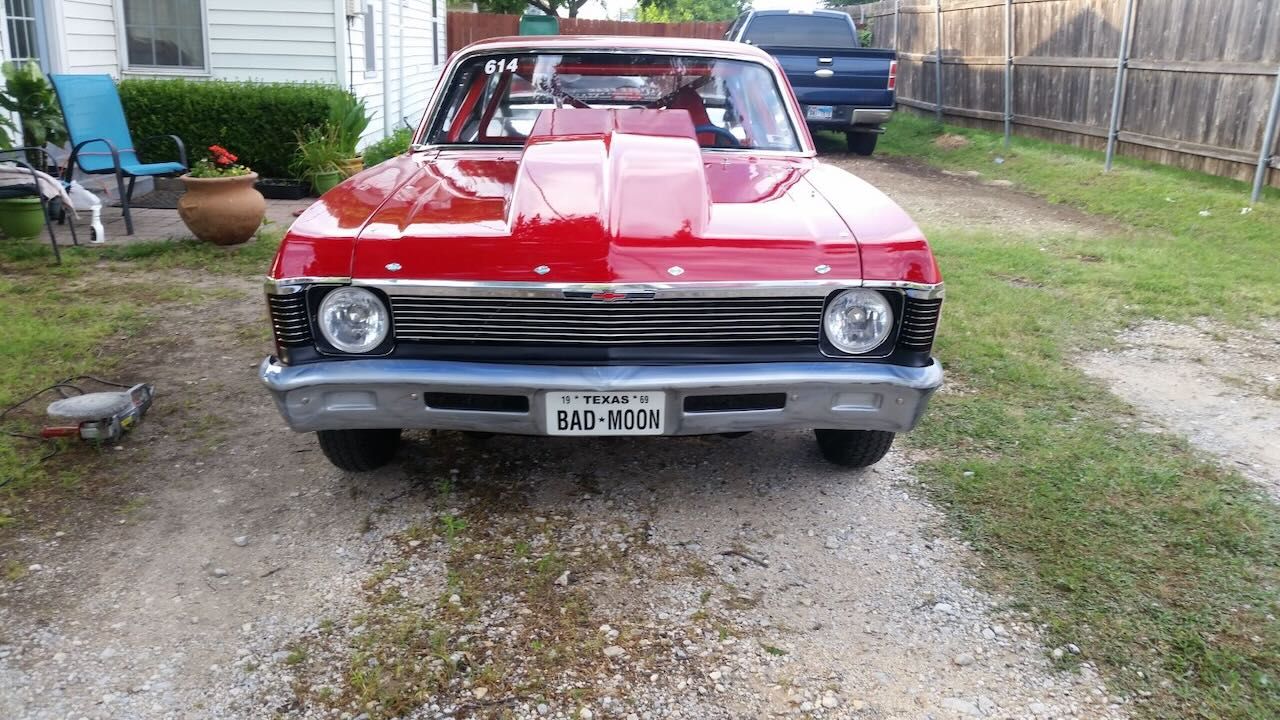 A red car with a license plate that says ' texas ' on it