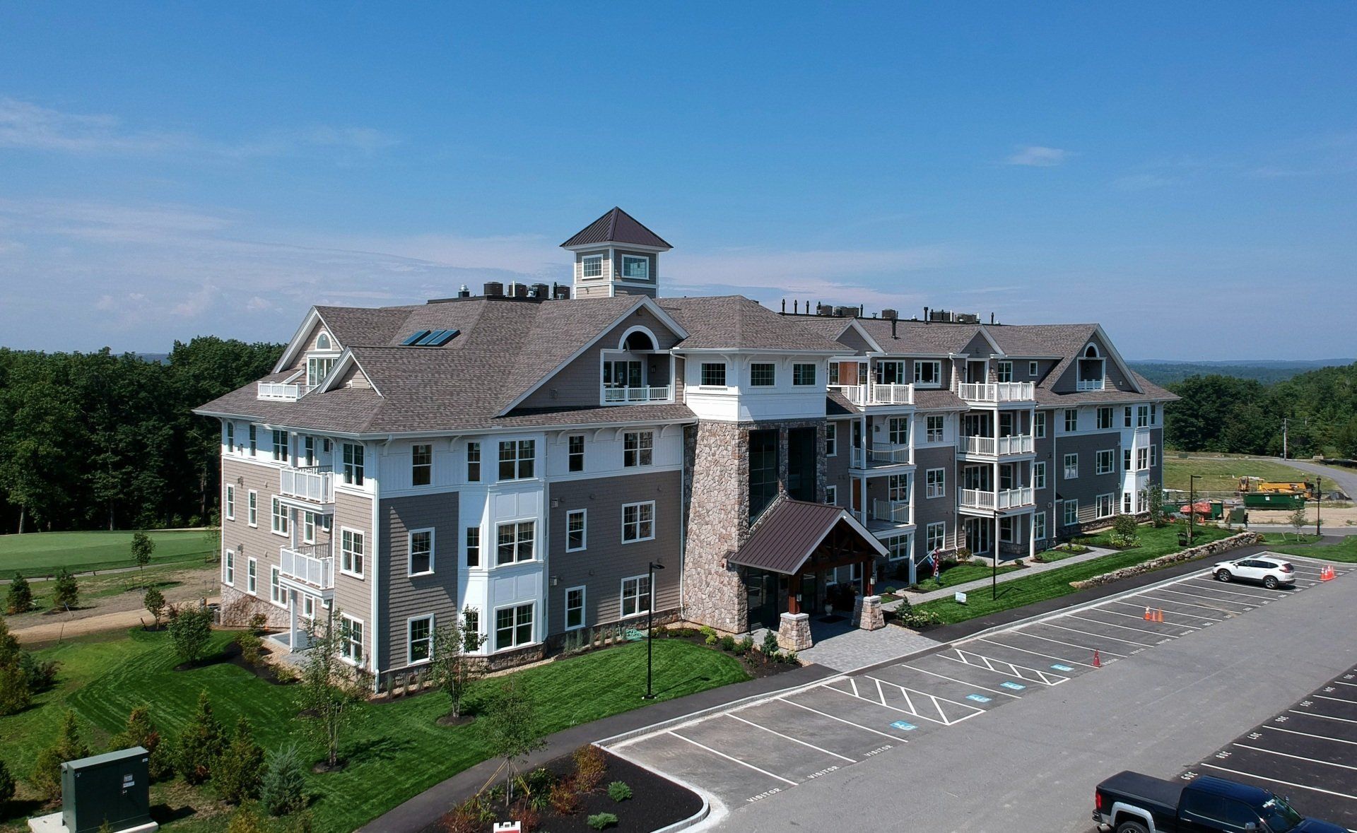An aerial view of a large building with a parking lot in front of it