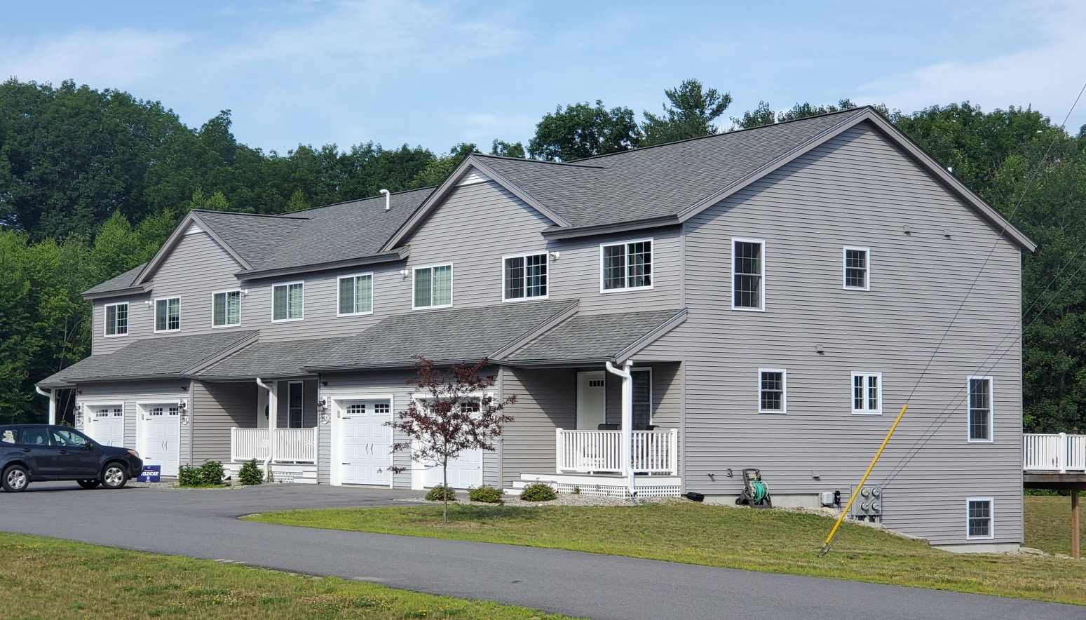 A large house with a car parked in front of it