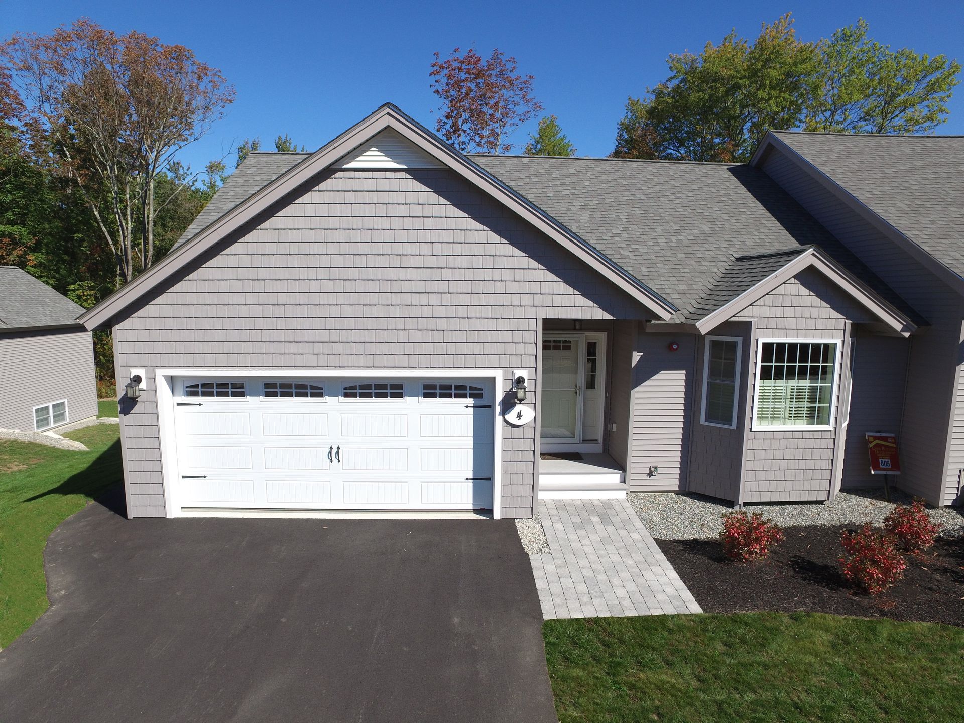 An aerial view of a house with a white garage door