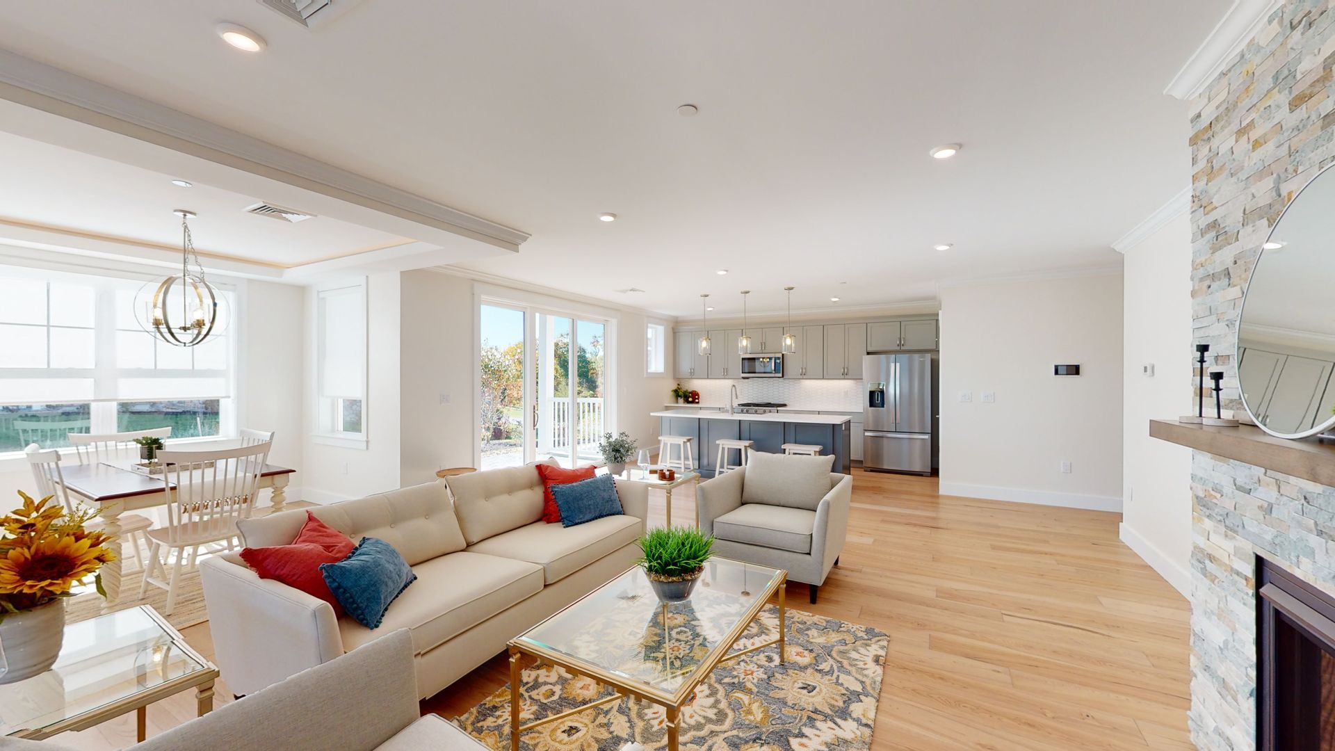 A living room with a couch , chair , coffee table and fireplace.