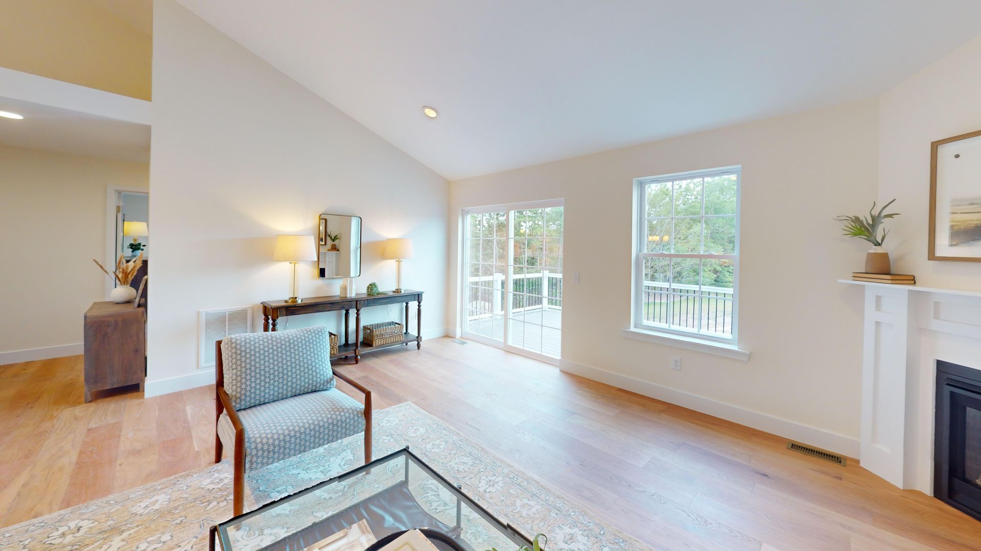 A kitchen with wooden cabinets , stainless steel appliances , a table and chairs.