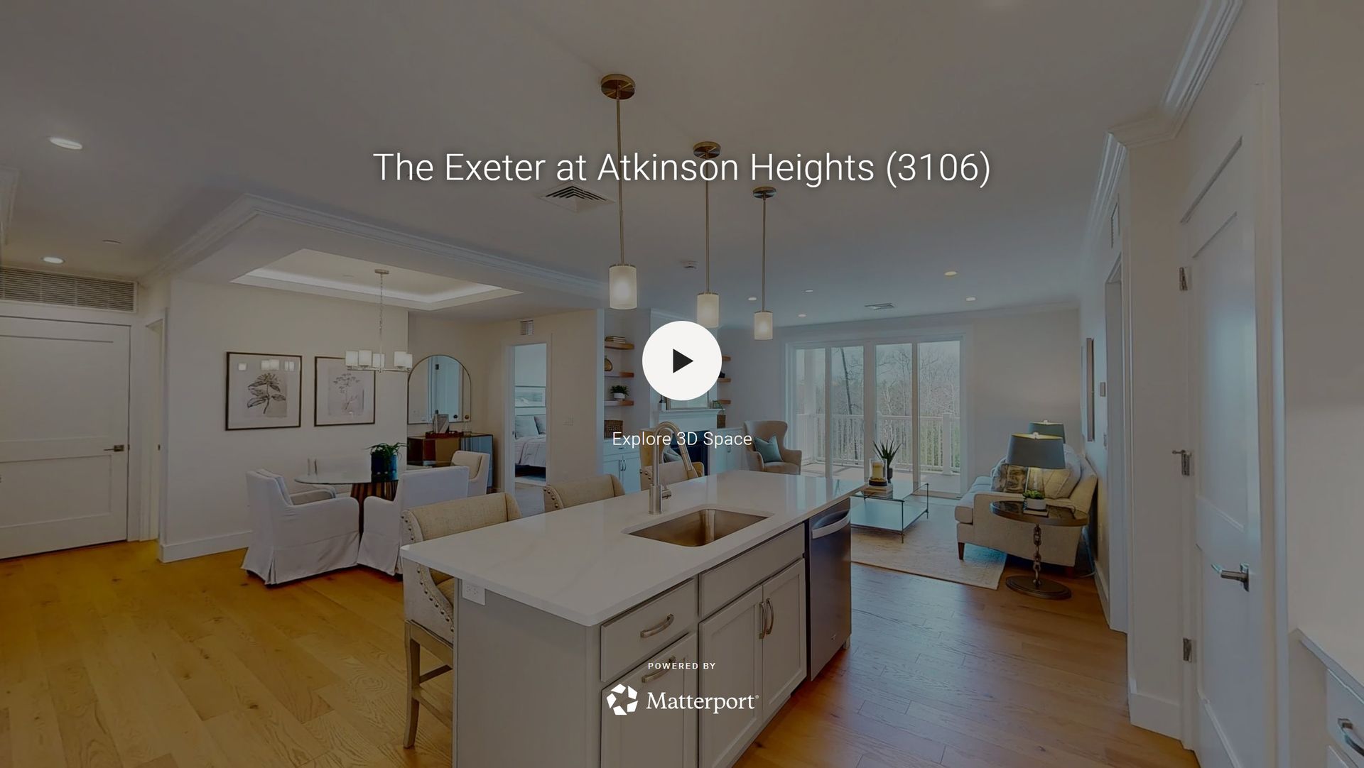 Bright open-plan living room and kitchen with white walls, wood floors, and modern decor.