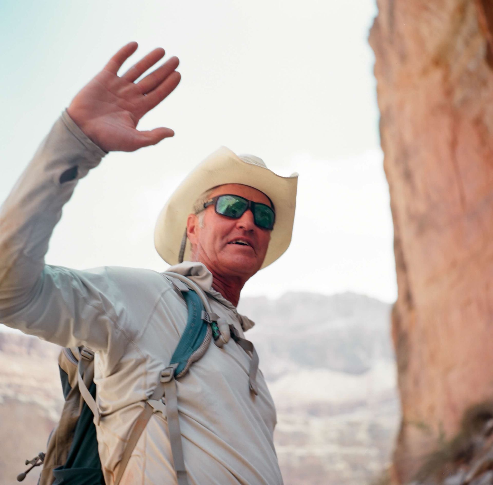 A man wearing a hat and a green shirt