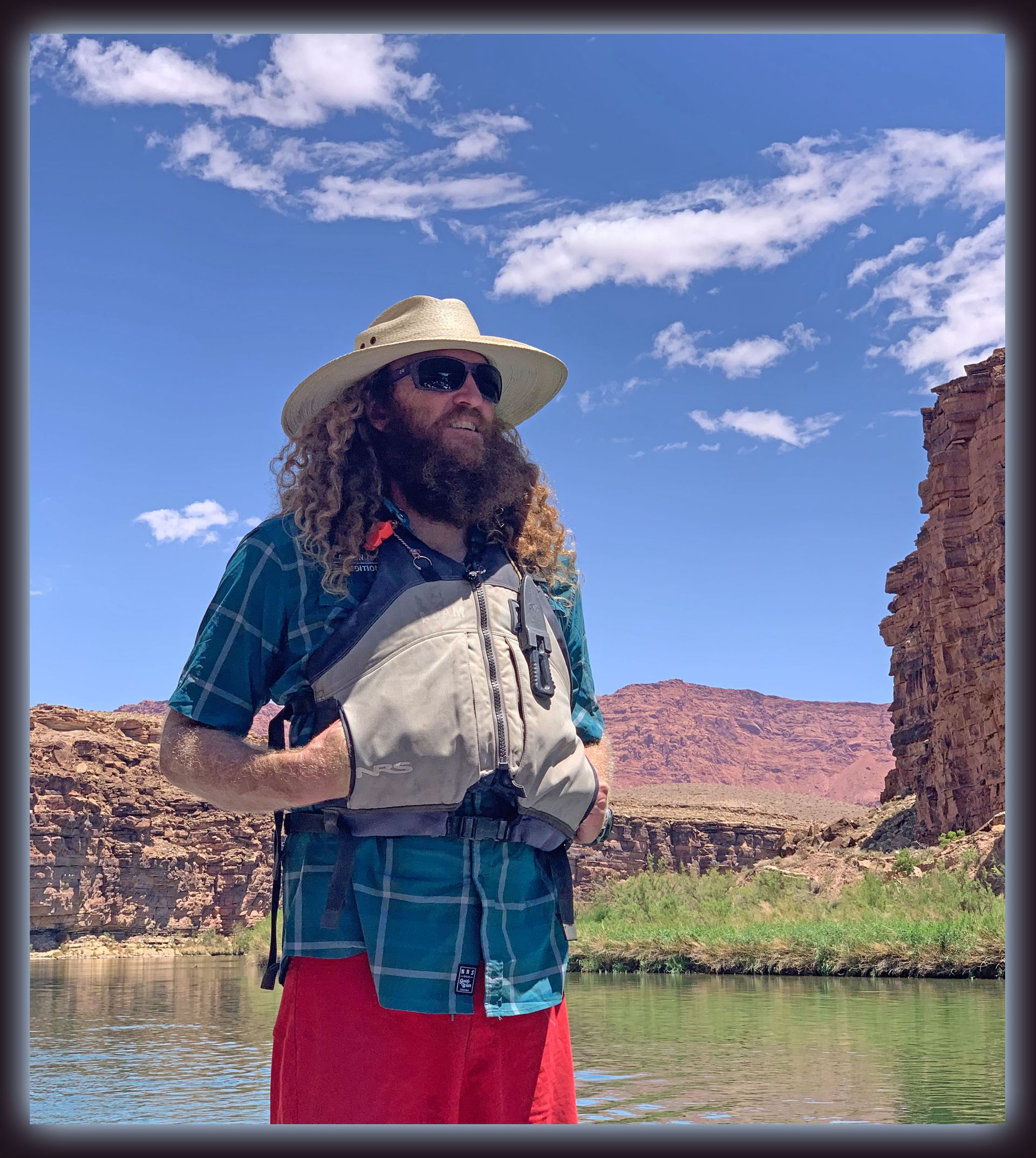 A man with a beard wearing sunglasses and a hat