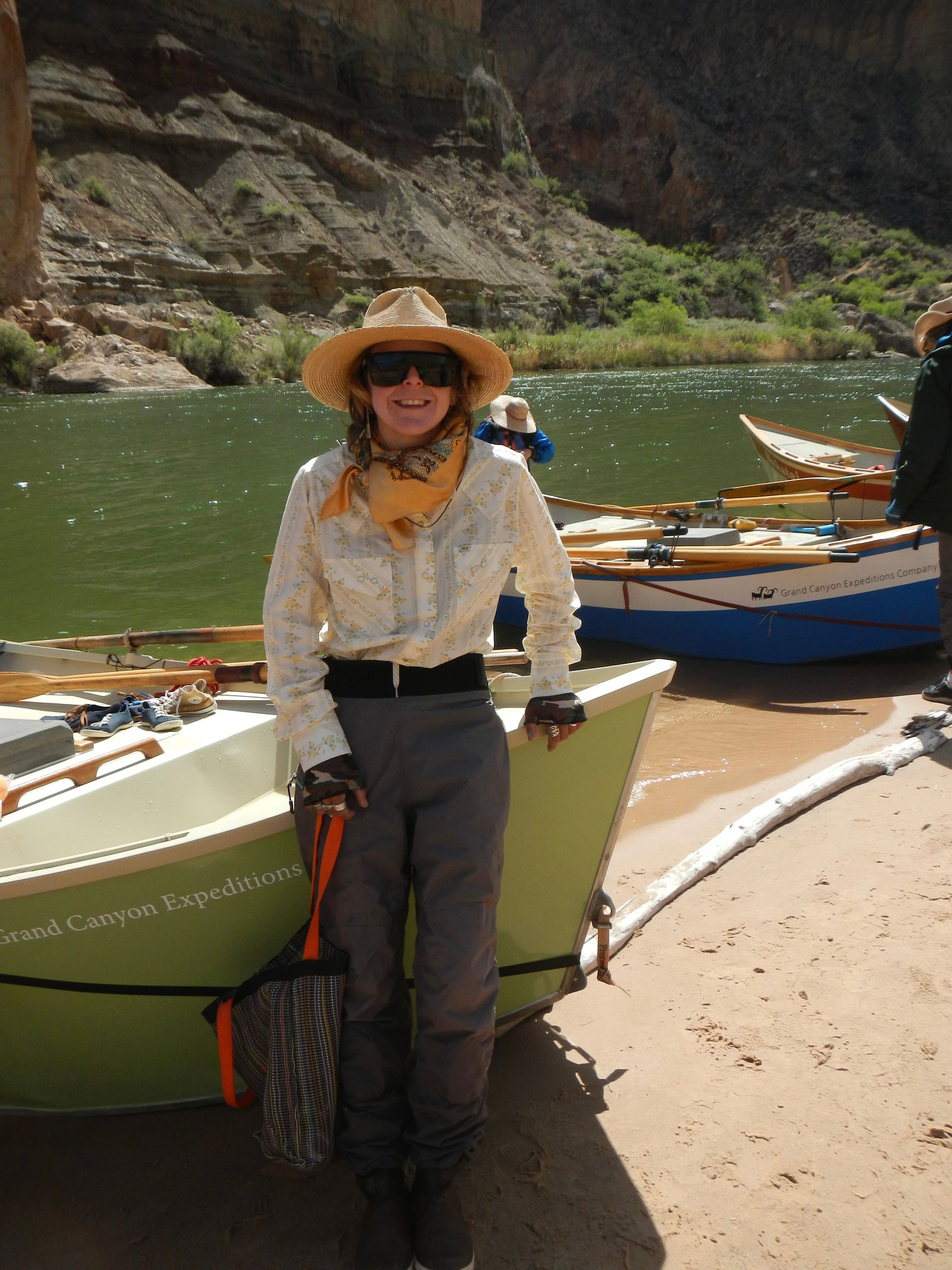 A woman in a hat is sitting in a boat