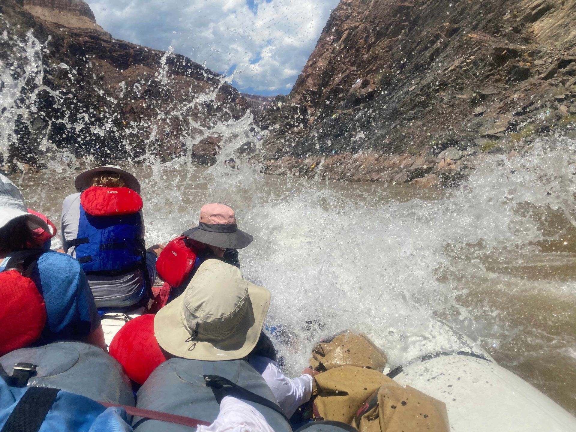 A group of people are rafting down a river