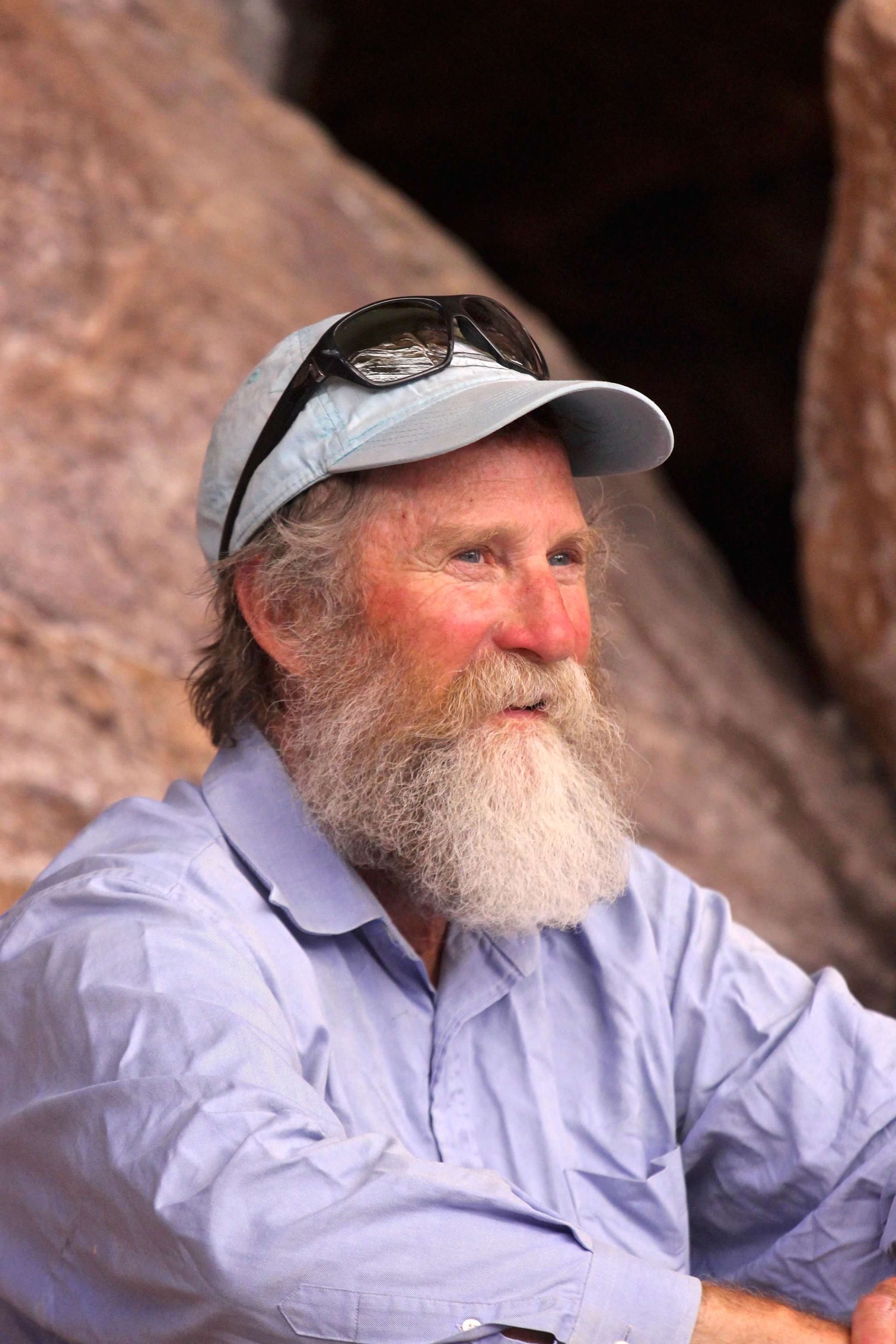A man with a beard wearing a hat and sunglasses