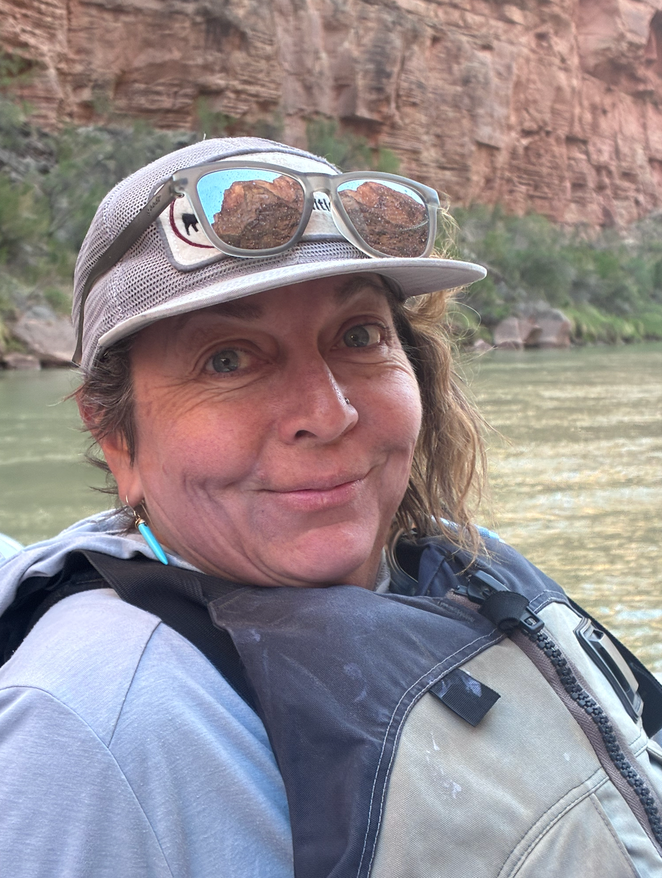 A woman is cutting vegetables on a cutting board.