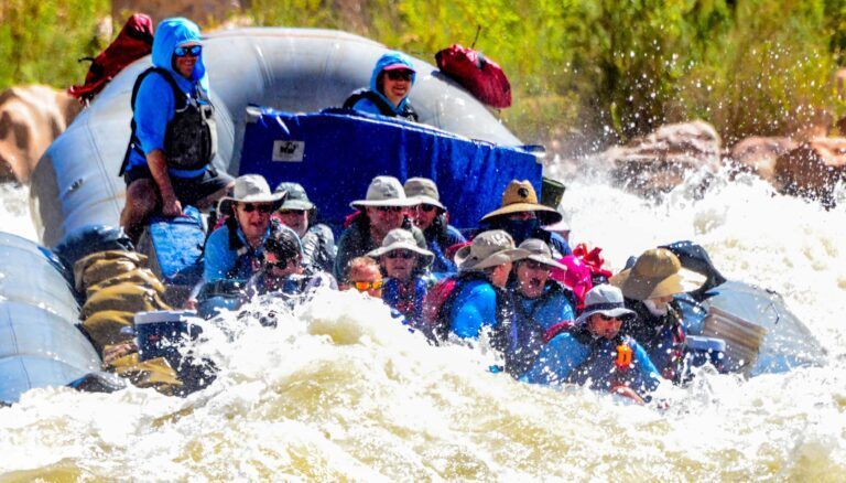 A group of people are rafting down a river in a raft.