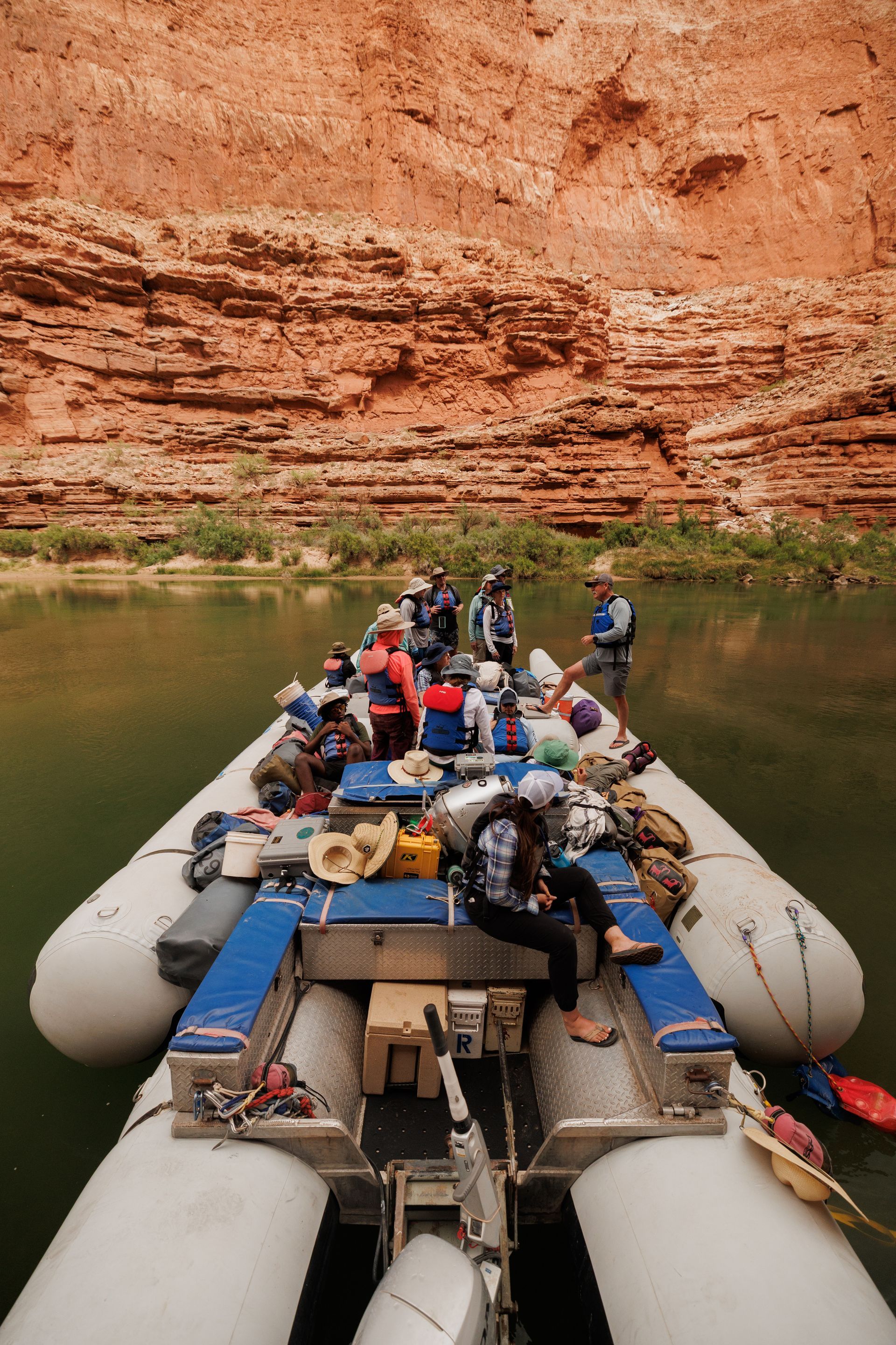 A man is rowing a boat down a river.