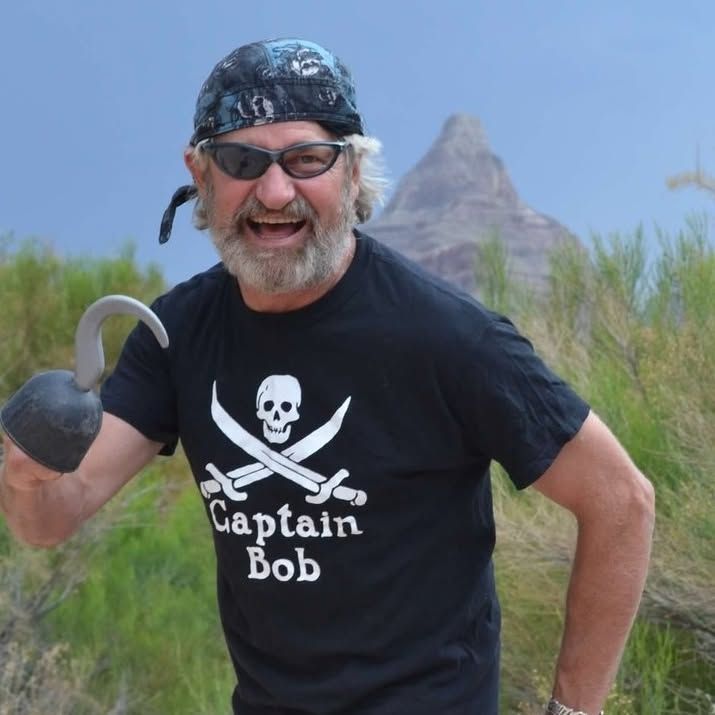 A man wearing a black shirt that says captain bob