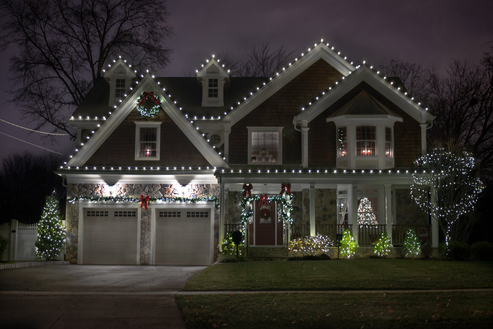 A house is decorated with christmas lights at night