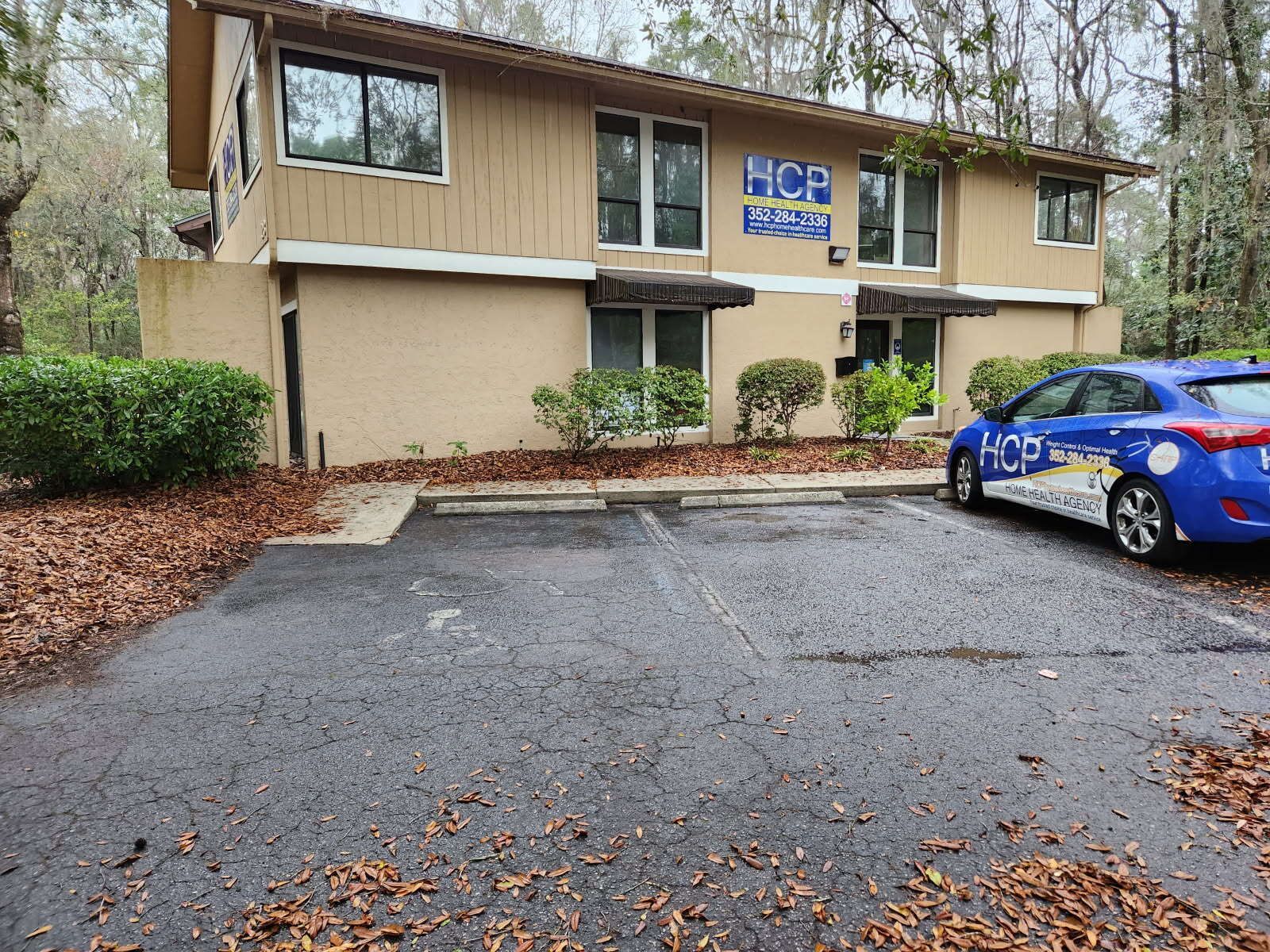 A motorcycle is parked in front of a building with the number 13 on it