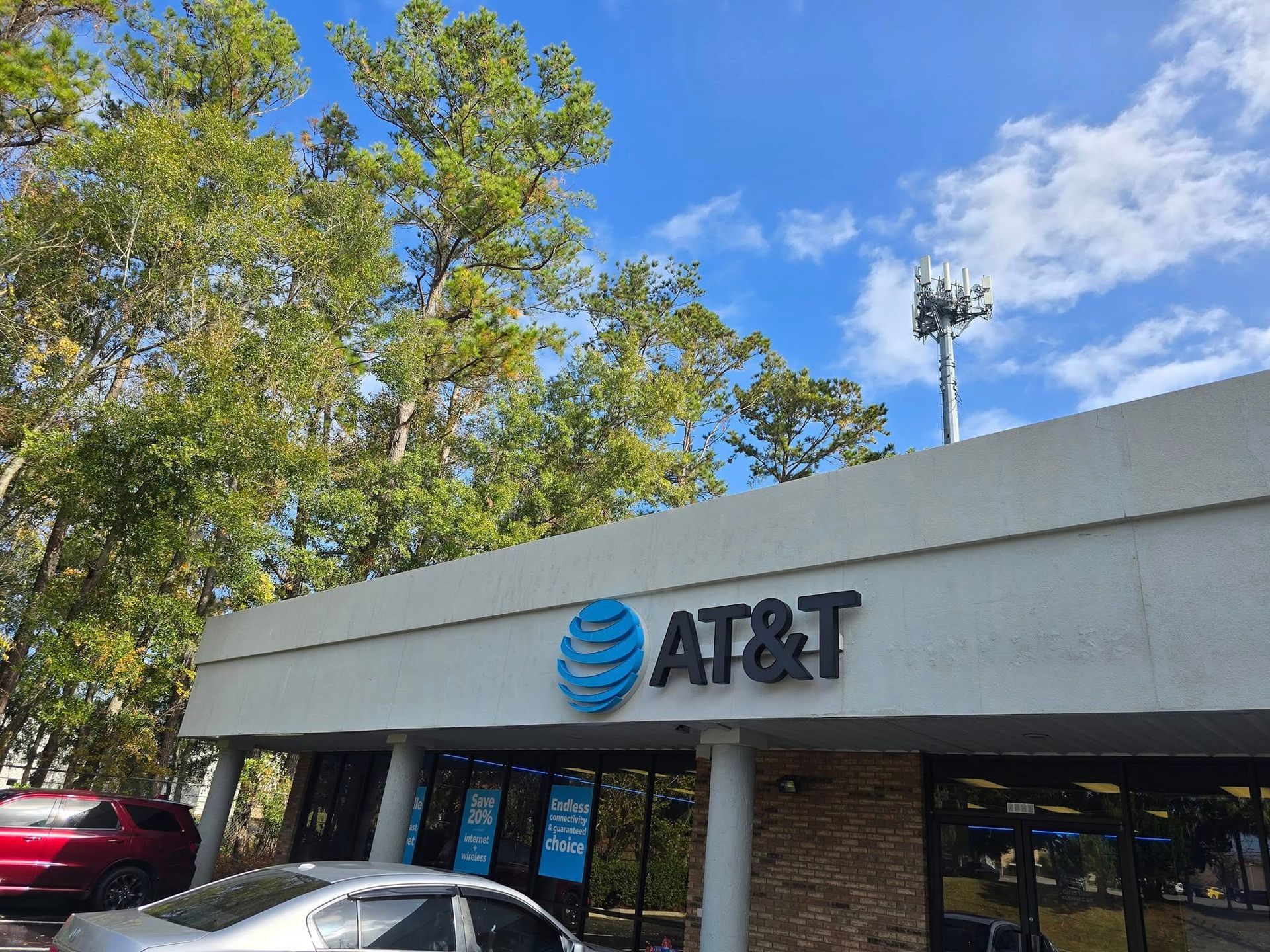 A car is parked in front of an at & t store