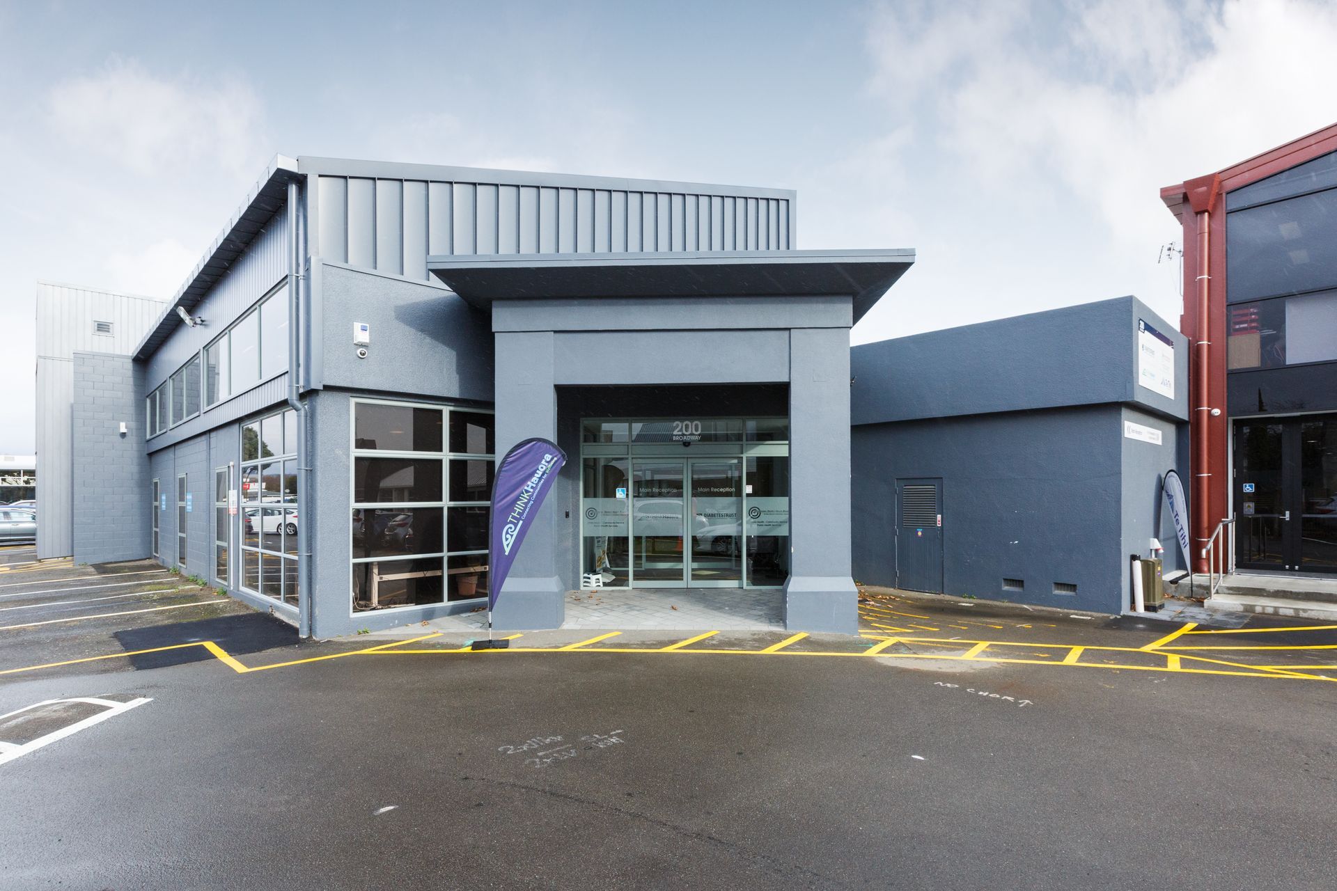 A large building with a purple flag in front of it
