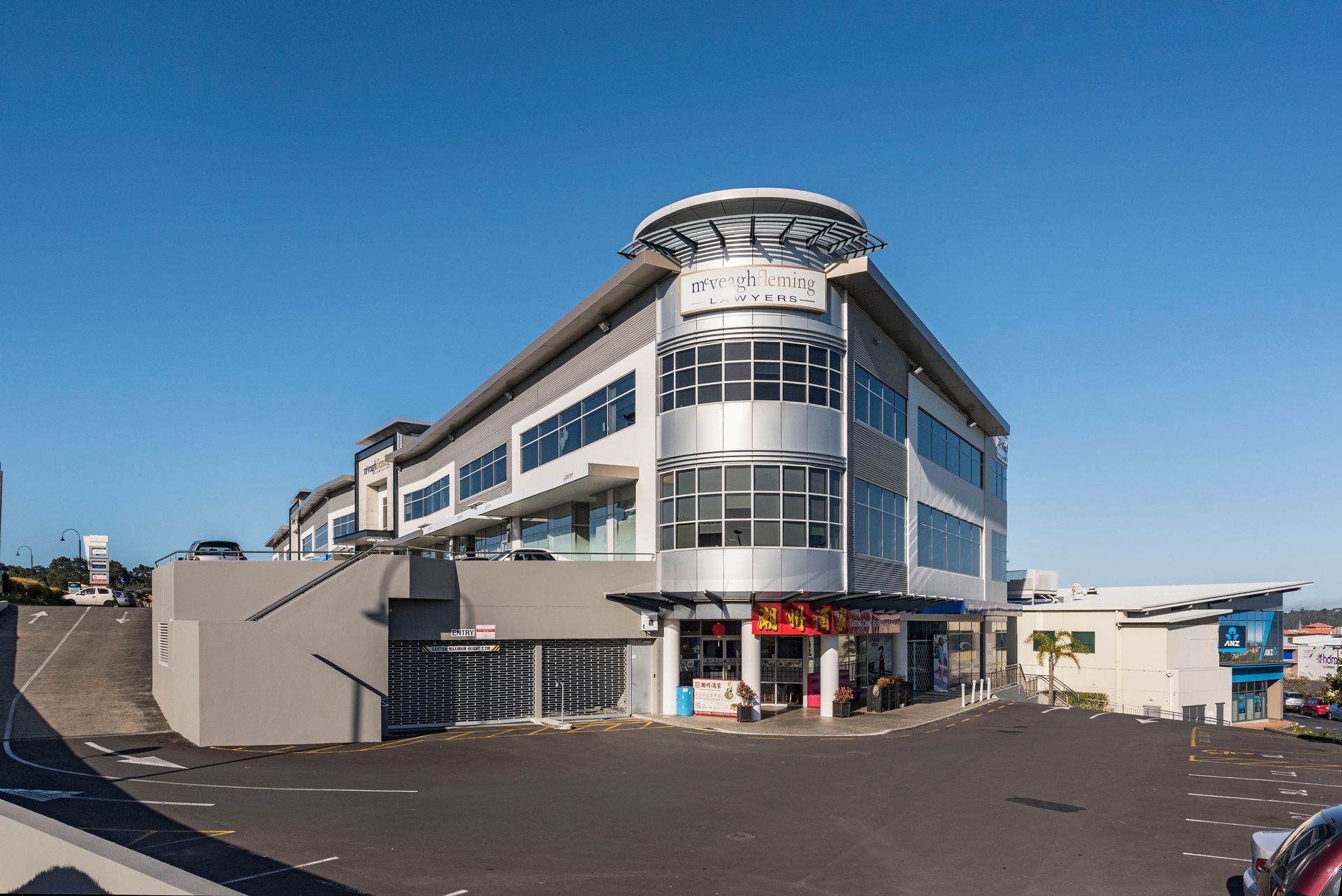 A large building with a lot of windows and a car parked in front of it.