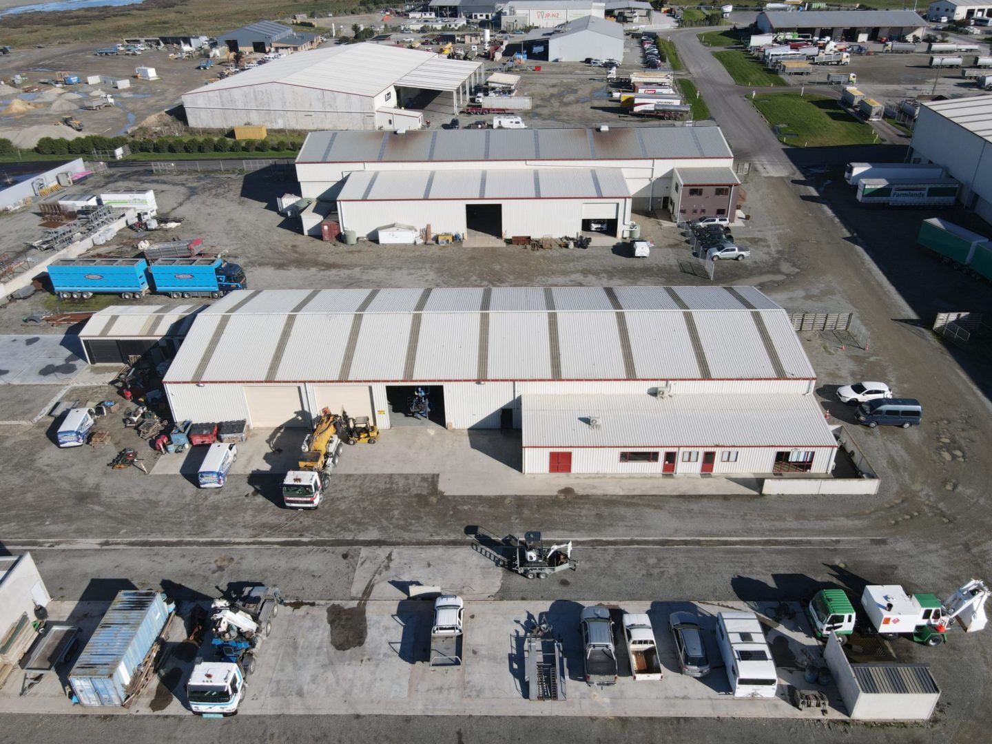 An aerial view of a warehouse with trucks parked in front of it