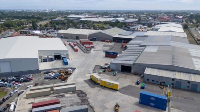 An aerial view of a warehouse filled with lots of containers.