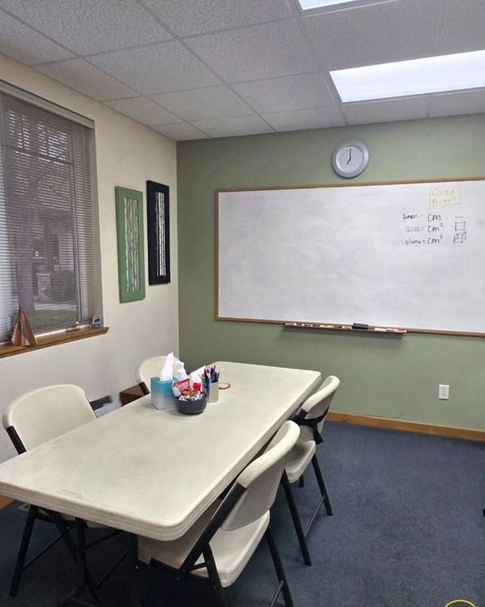 inside view of mathworks bozeman math tutor office with table and whiteboard
