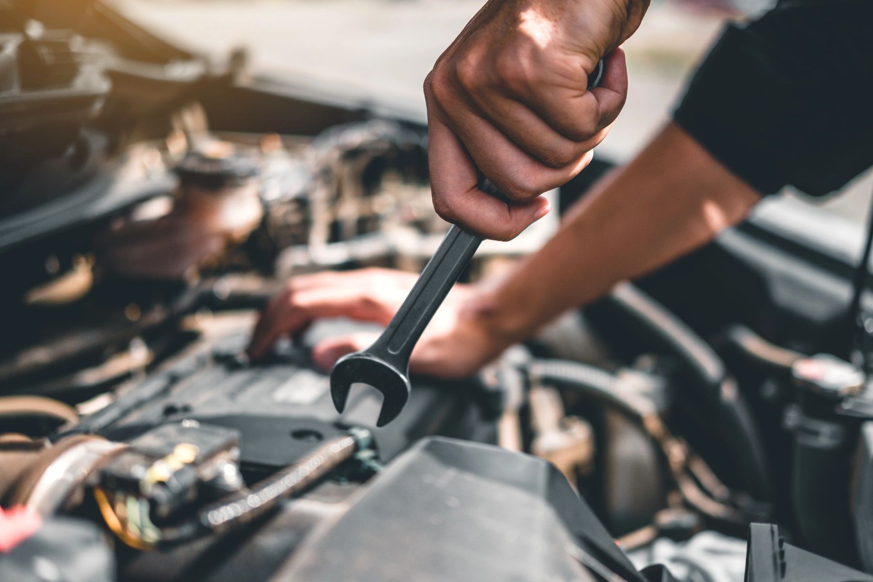 Hand Tightening a Ratchet Wrench on A Car Engine — Geelong Car Repair Centre in Newcomb, VIC