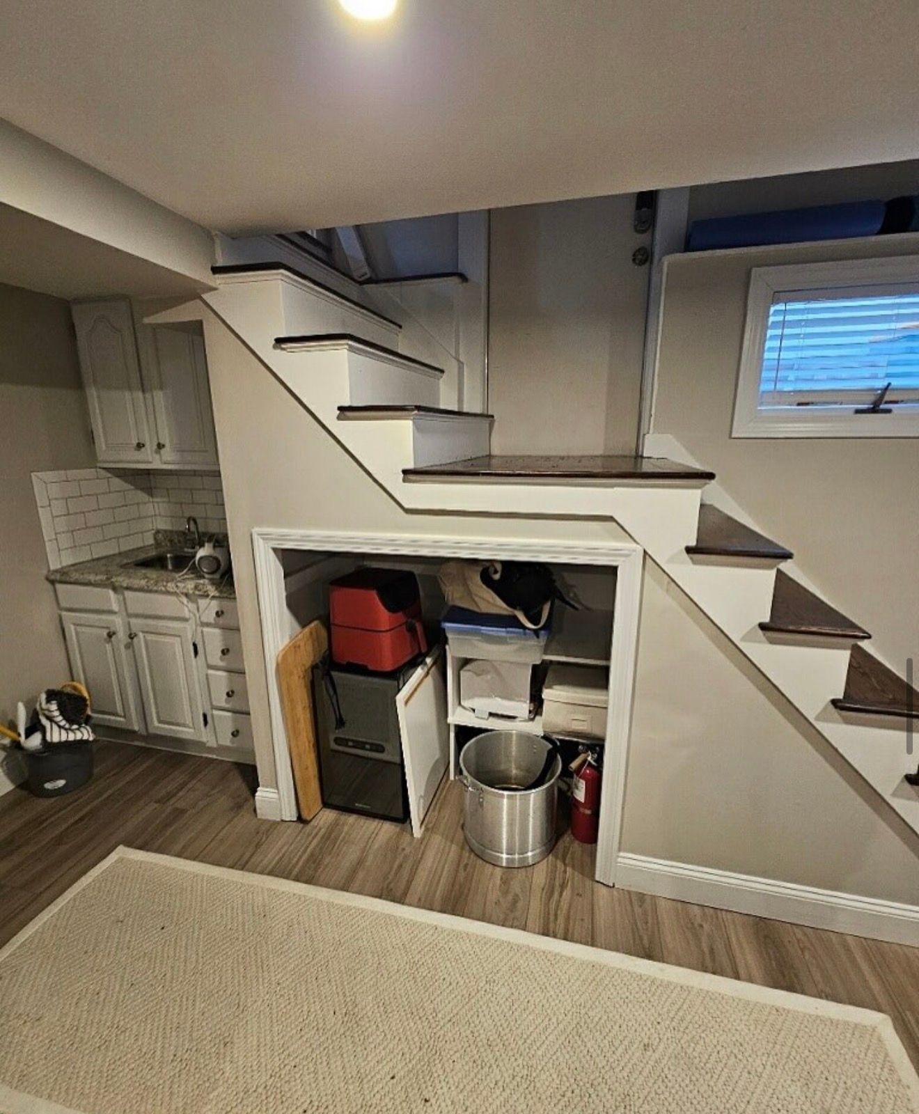 Before: Unused wet bar and open under-stair storage in a Winthrop MA basement before remodeling