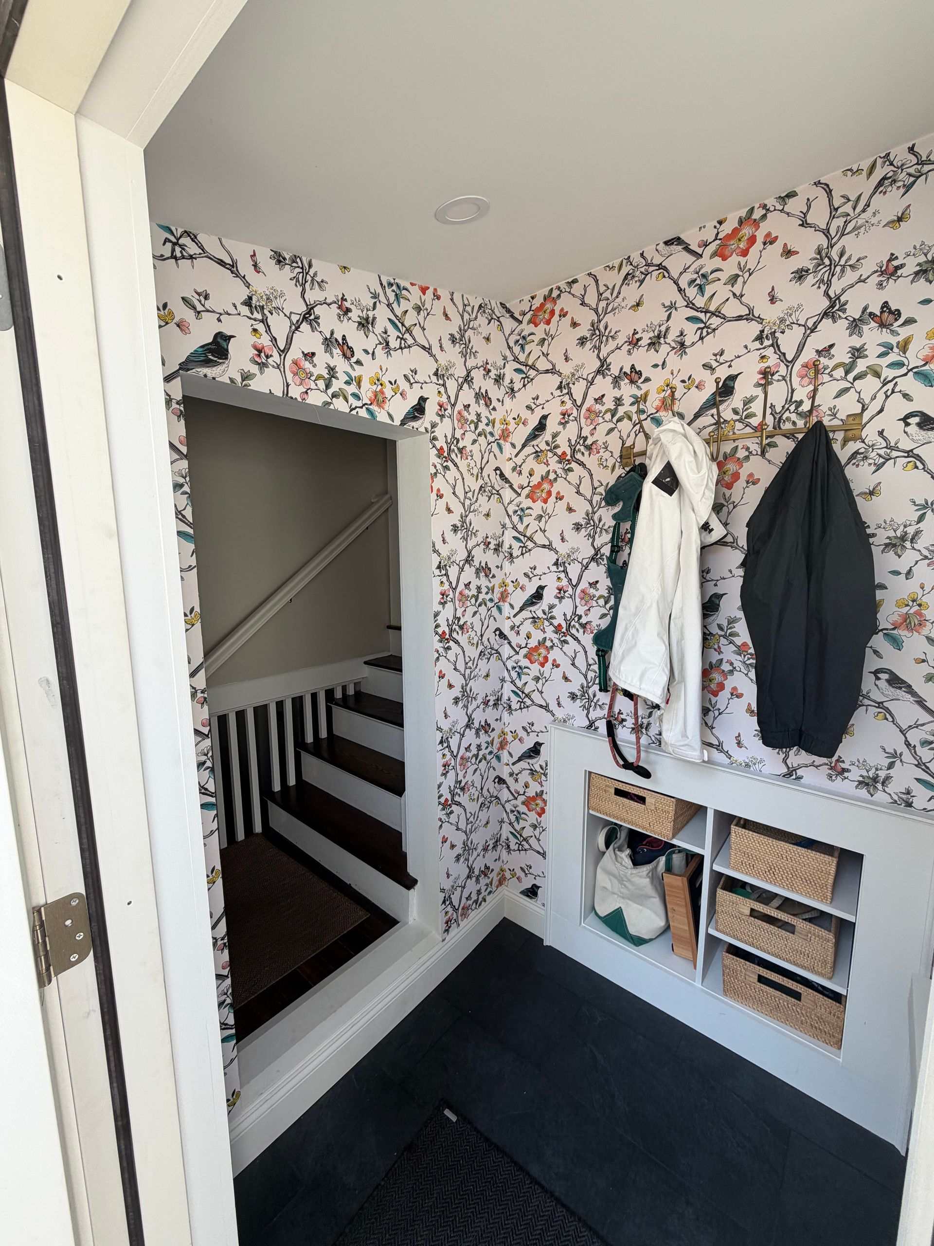 Custom recessed storage shelving built directly into the mudroom wall during construction