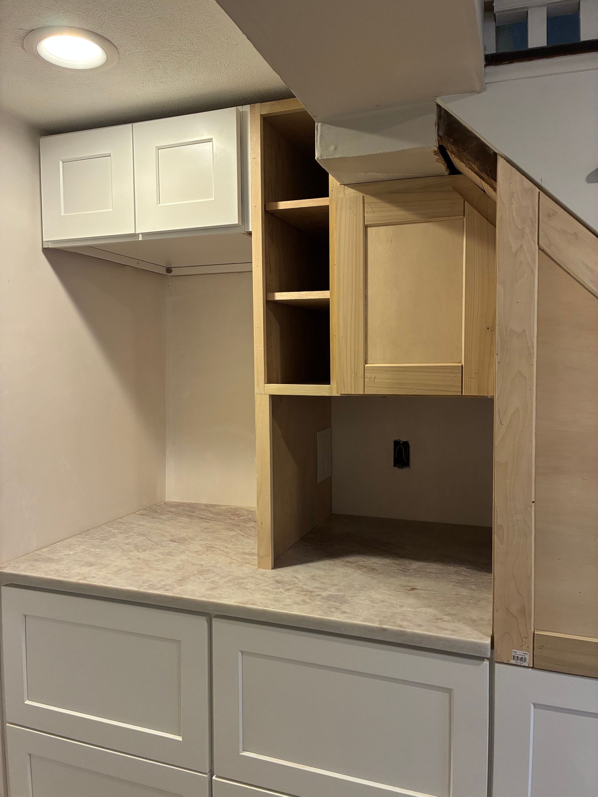 Under construction finished custom cabinetry with wine fridge casement and deep drawers in Winthrop MA
