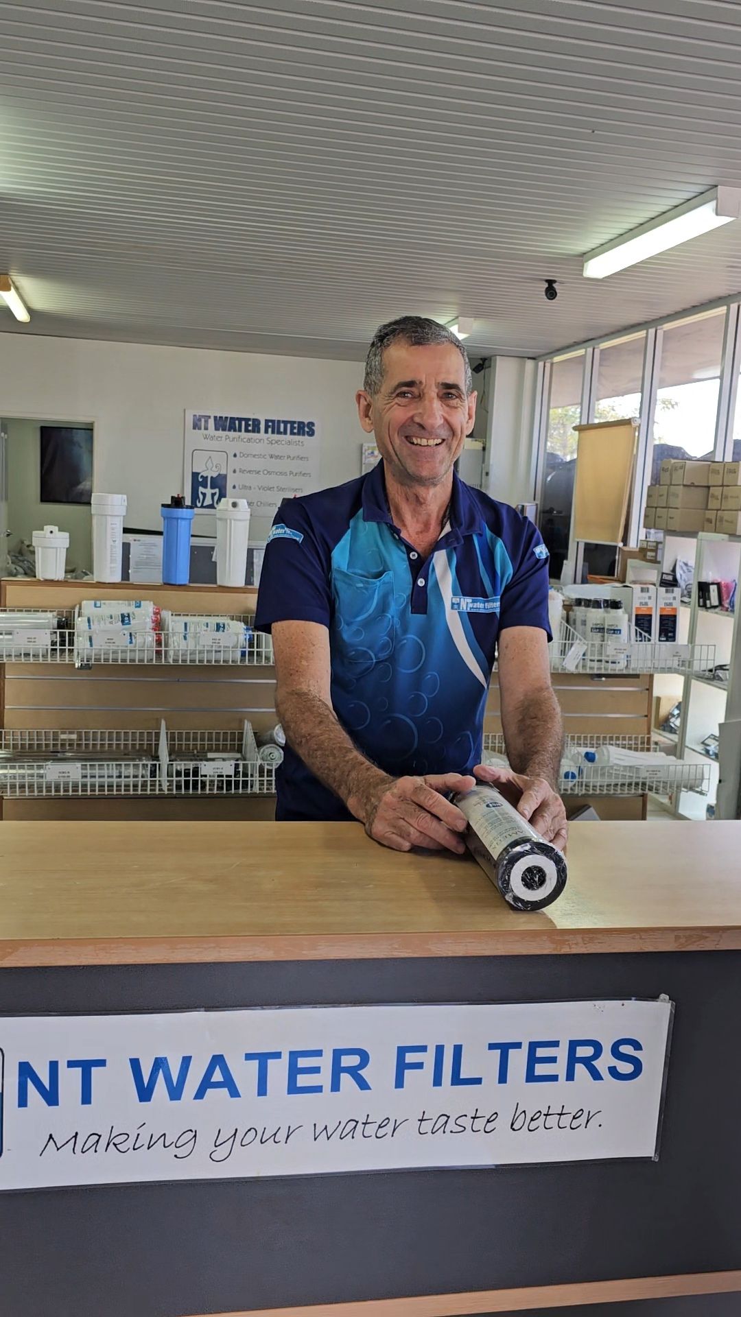 Man At Shop Counting Smiling With Water Filter— NT Water Filters In Winnellie, NT