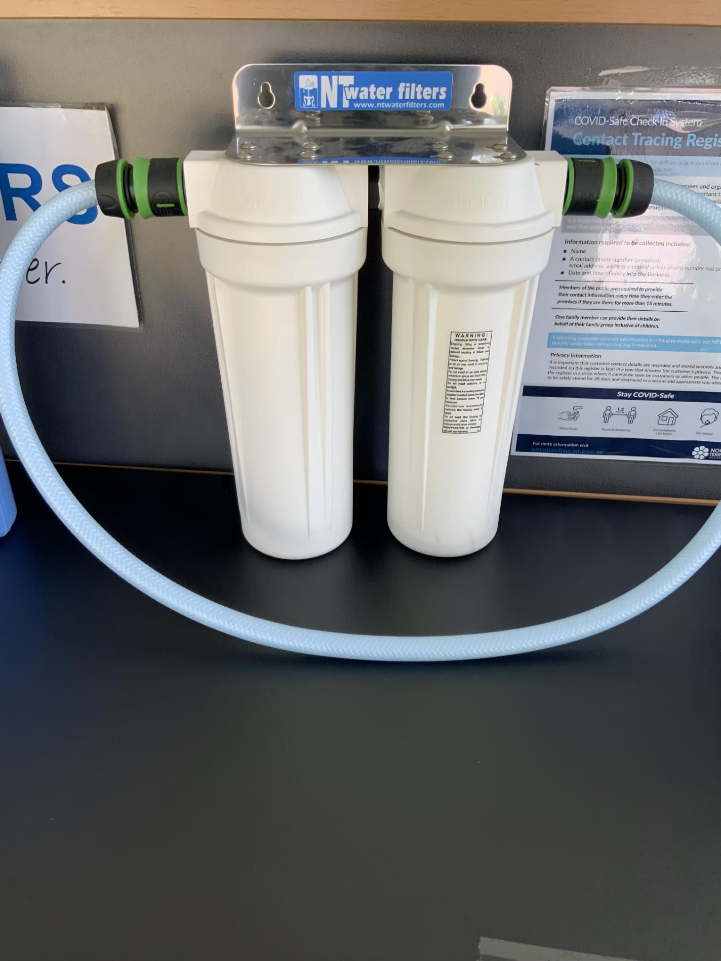 Two Water Filters Are Sitting on a Table With a Hose Attached to Them — NT Water Filters In Winnellie, NT