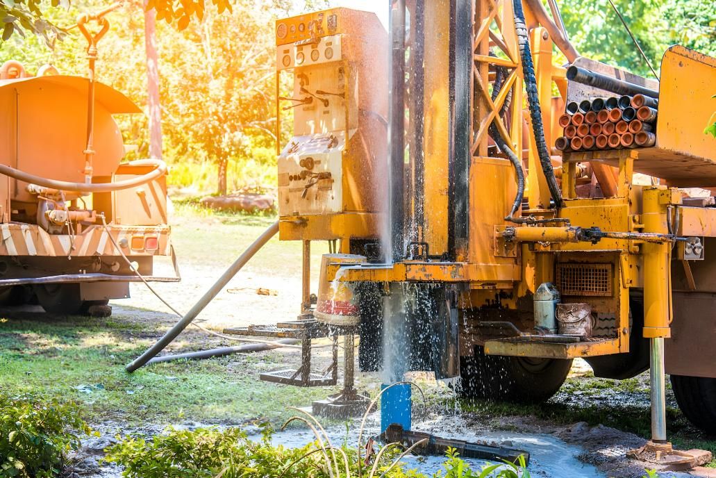 A Water Pump is Being Used to Pump Water Into a Well — NT Water Filters In Winnellie, NT