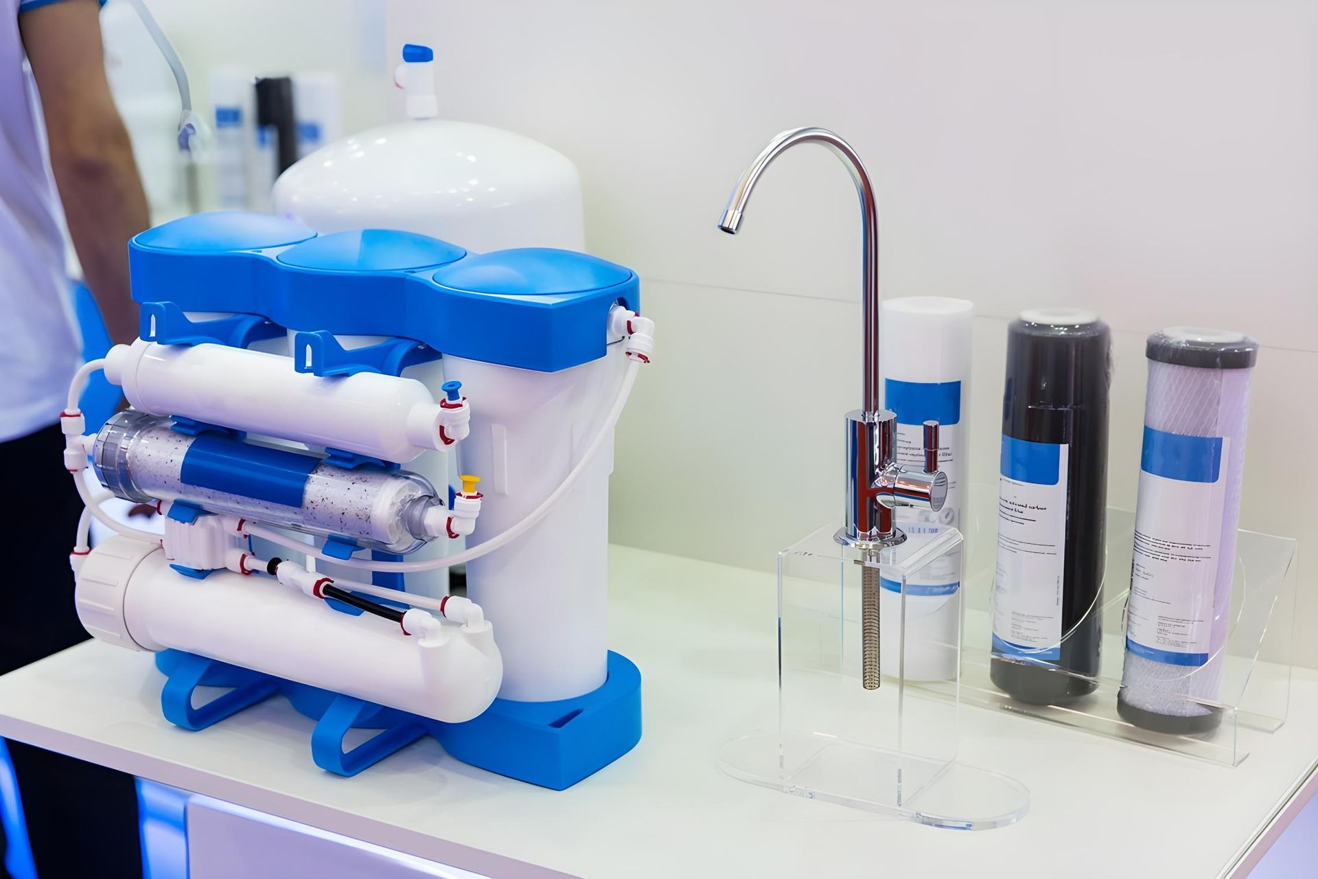 A Water Filter is Sitting on a Table Next to a Faucet — NT Water Filters In Winnellie, NT