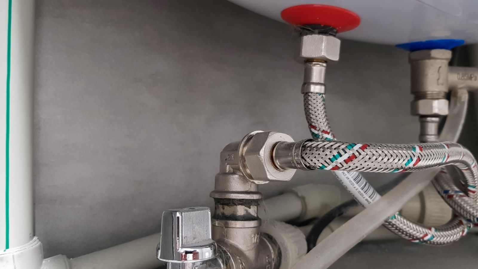 A Close Up of a Water Heater With a Hose Attached to It — Fig Facility Services in Lara, VIC