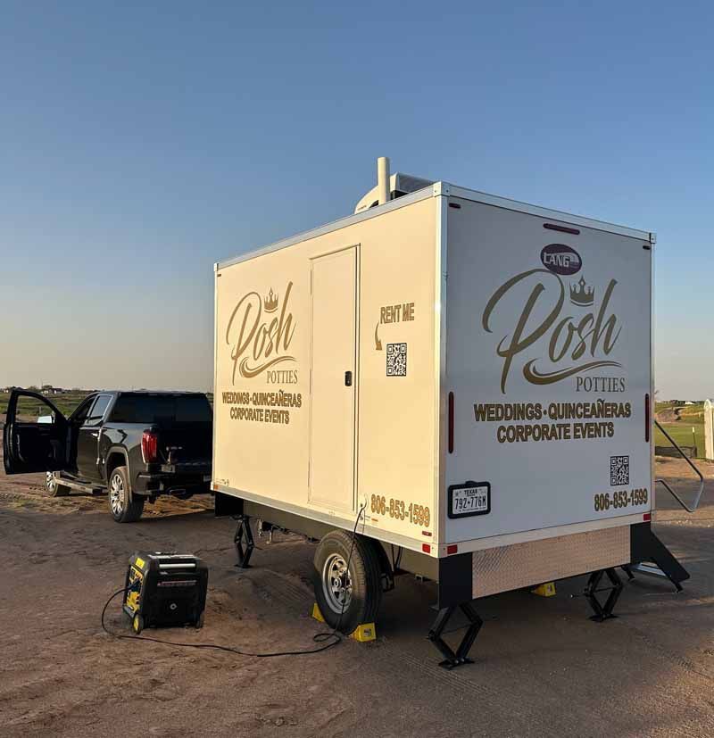 A portable restroom trailer, labeled 