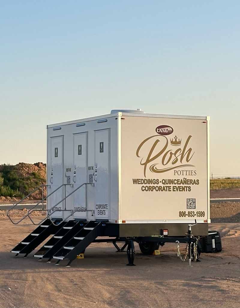White portable restroom trailer with steps, logo 