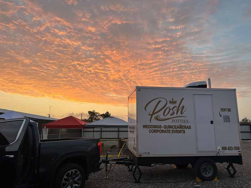 A portable restroom trailer labeled 