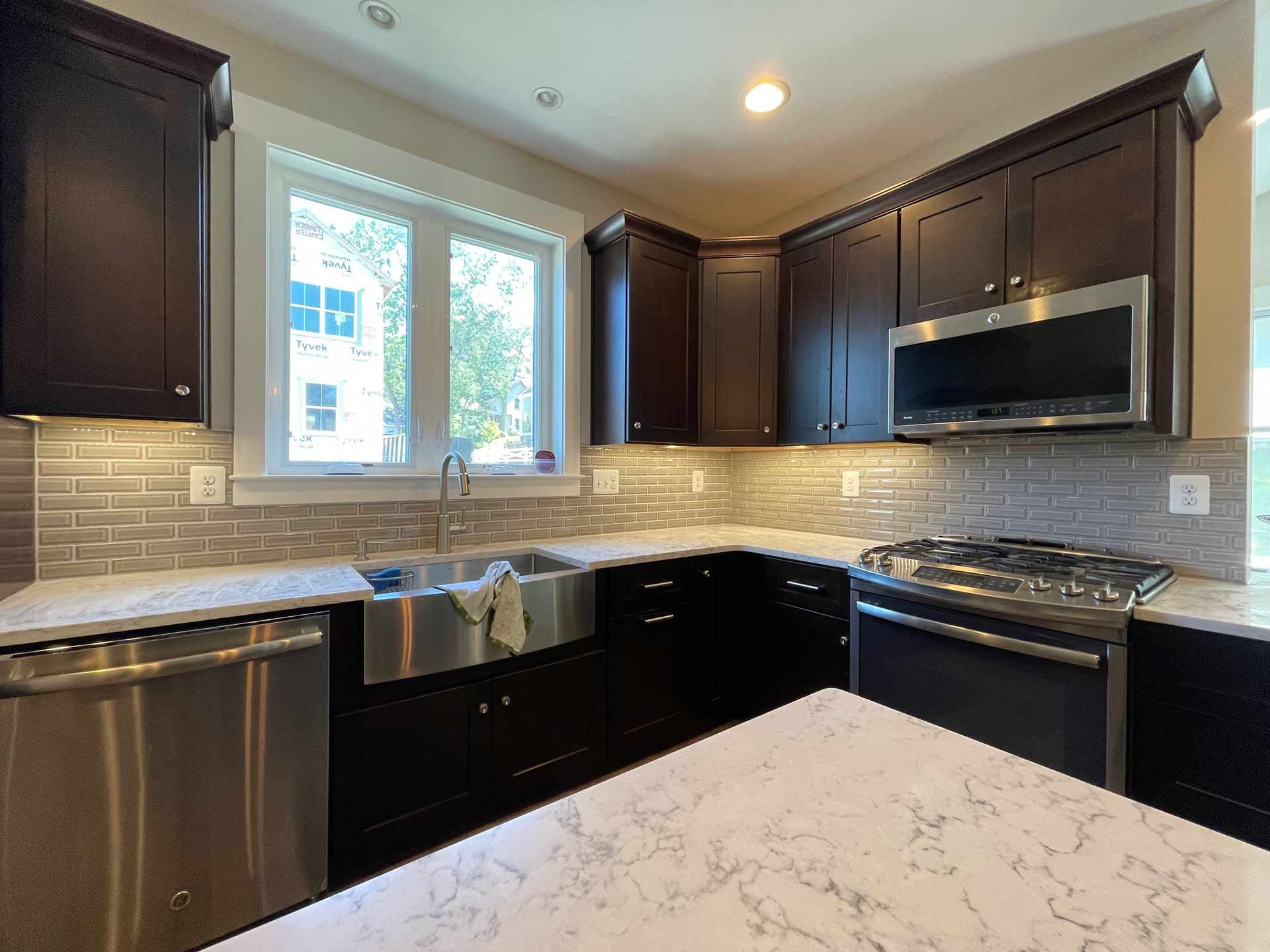 A kitchen with stainless steel appliances and a large island