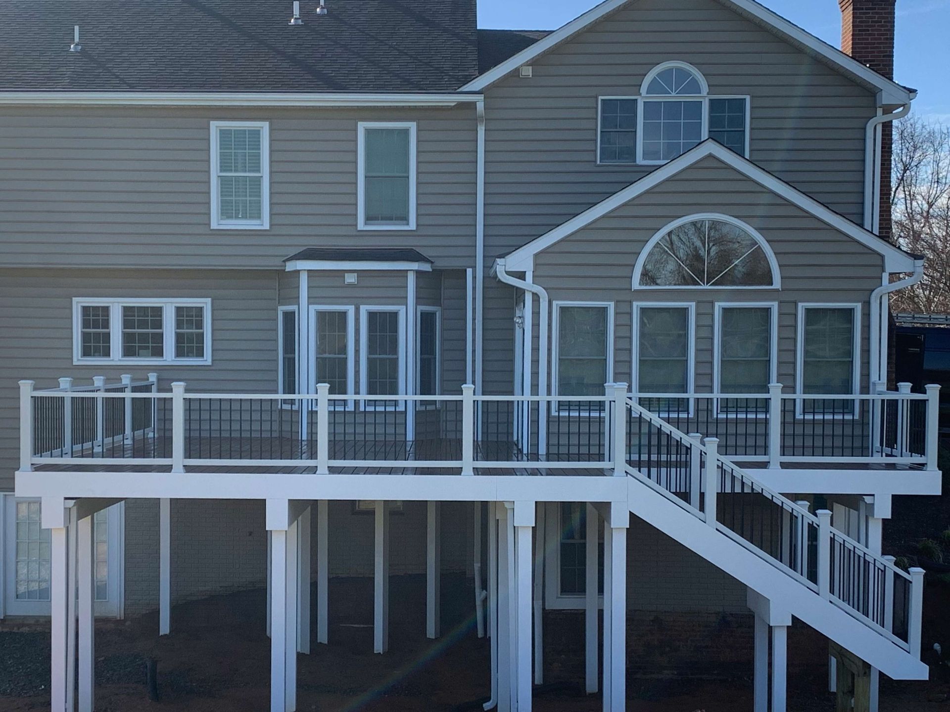 A large house with a large deck and stairs