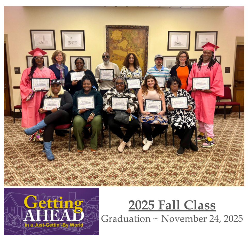 Group of people holding certificates, celebrating 2025 Fall Graduation. Formal room setting with artwork.