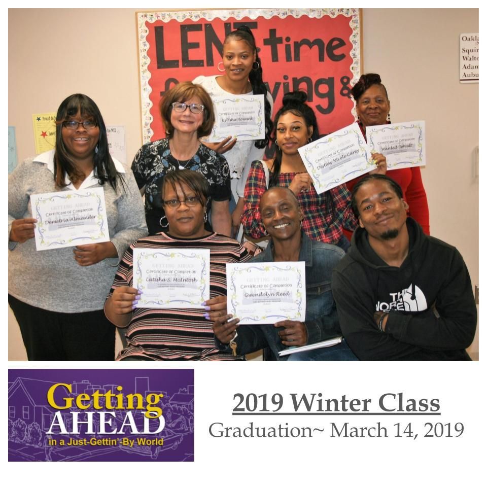 Group of diverse people at graduation, holding certificates.