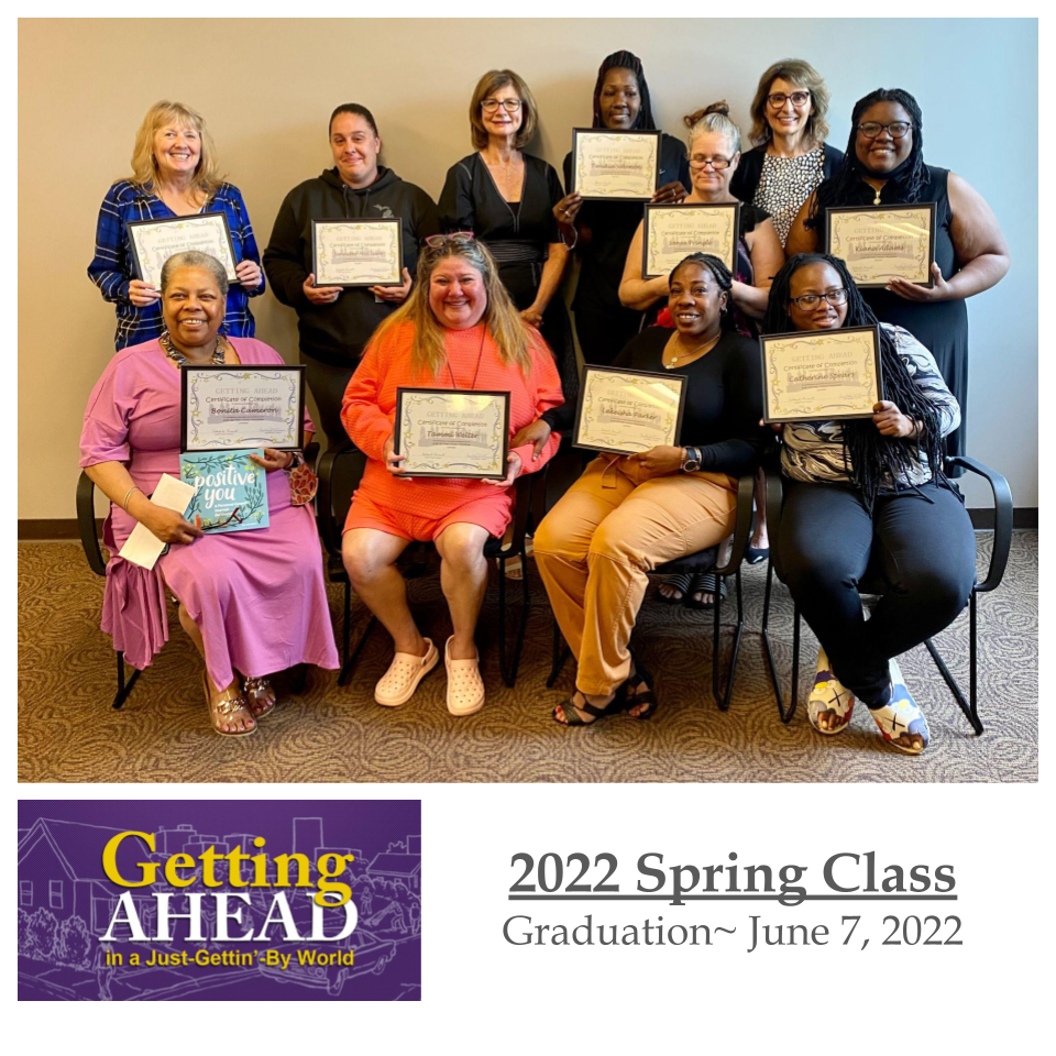 Group of people holding certificates, smiling, in a graduation ceremony. 2022 Spring Class,