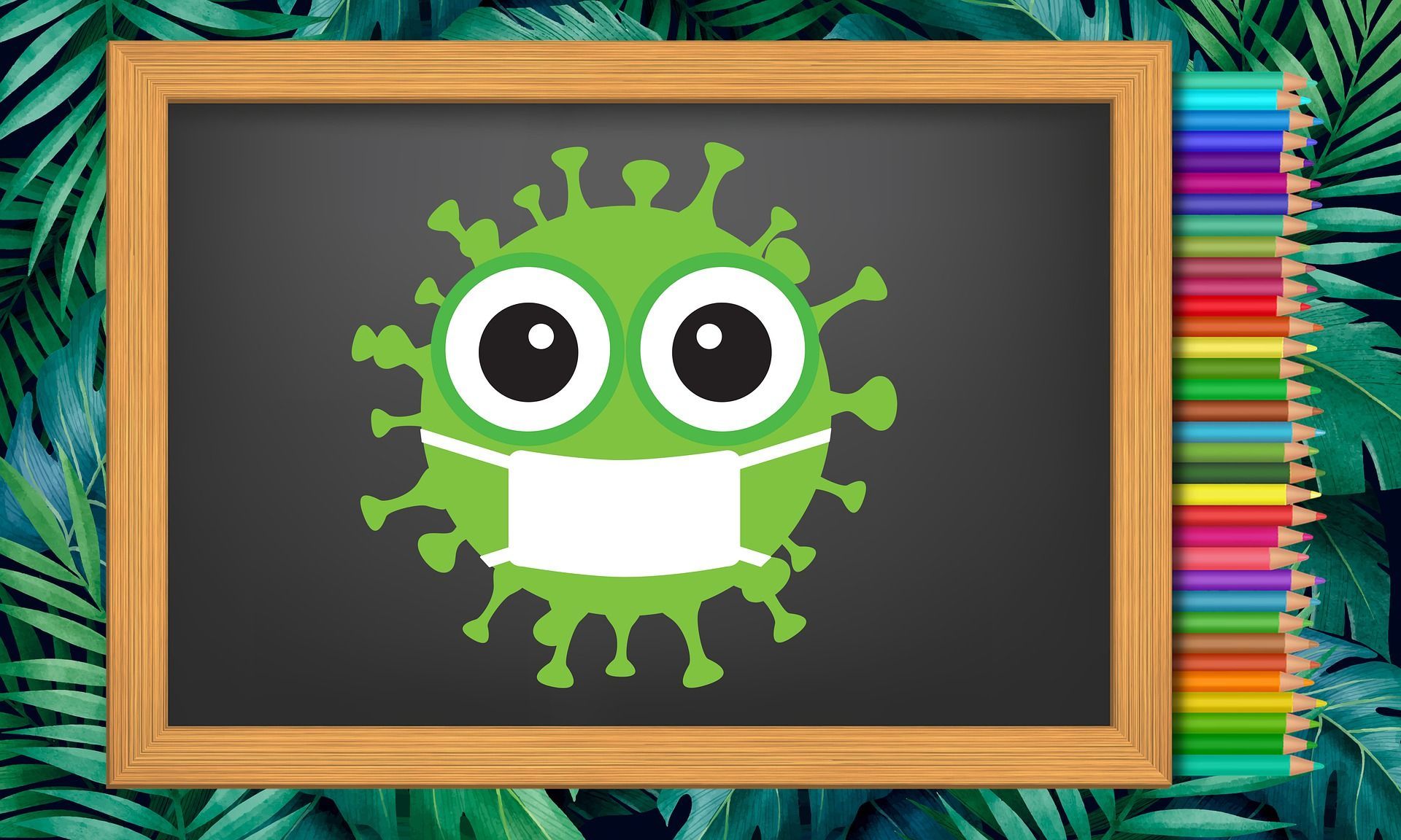 A cartoon virus with a mask on a blackboard with colored pencils.