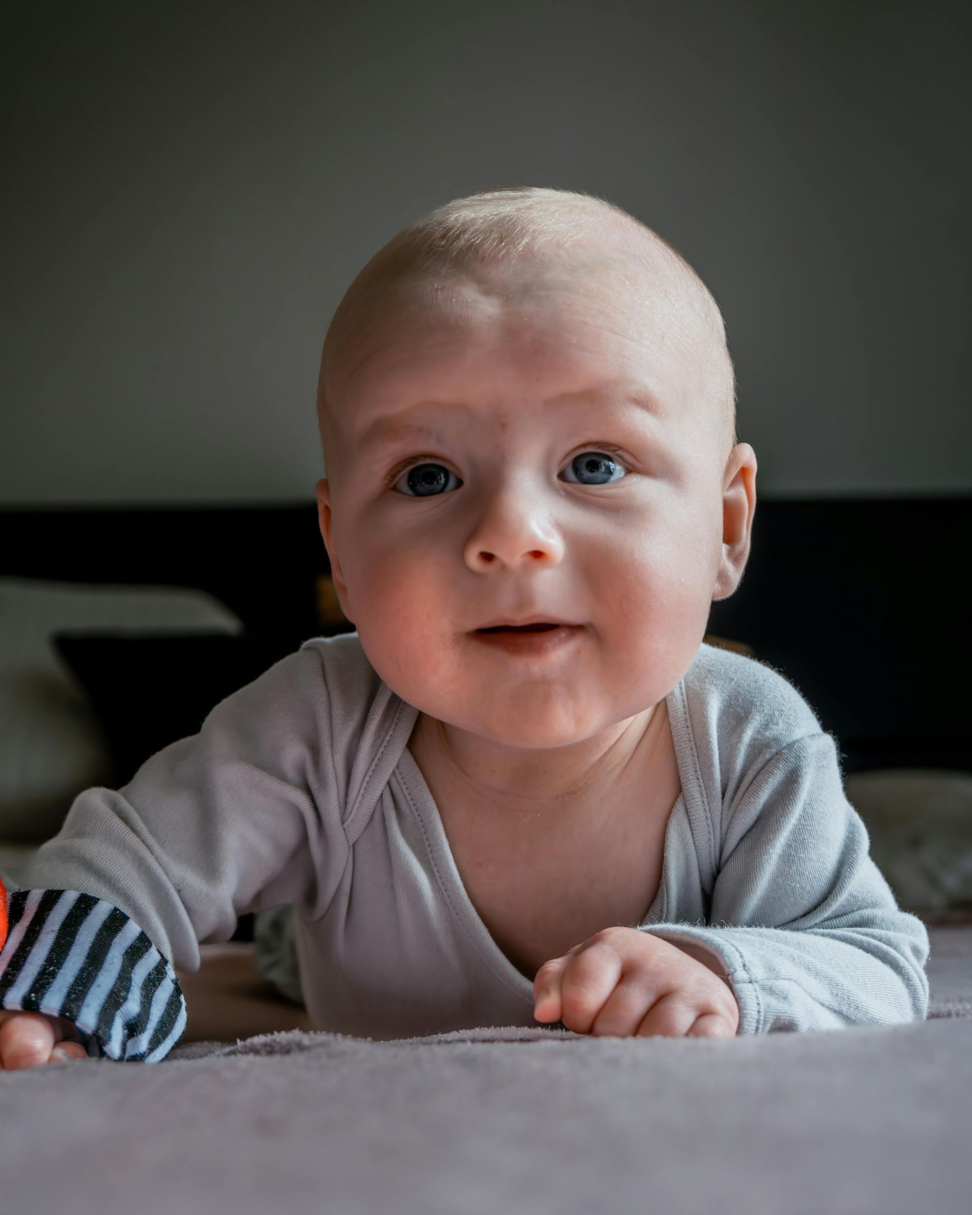 A young baby on its stomach.