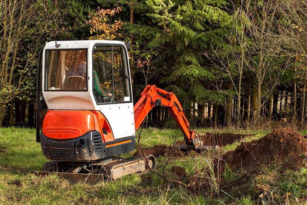 Small Excavator On The Field — Carlisle, PA — Elwood B. Shughart & Sons Excavating