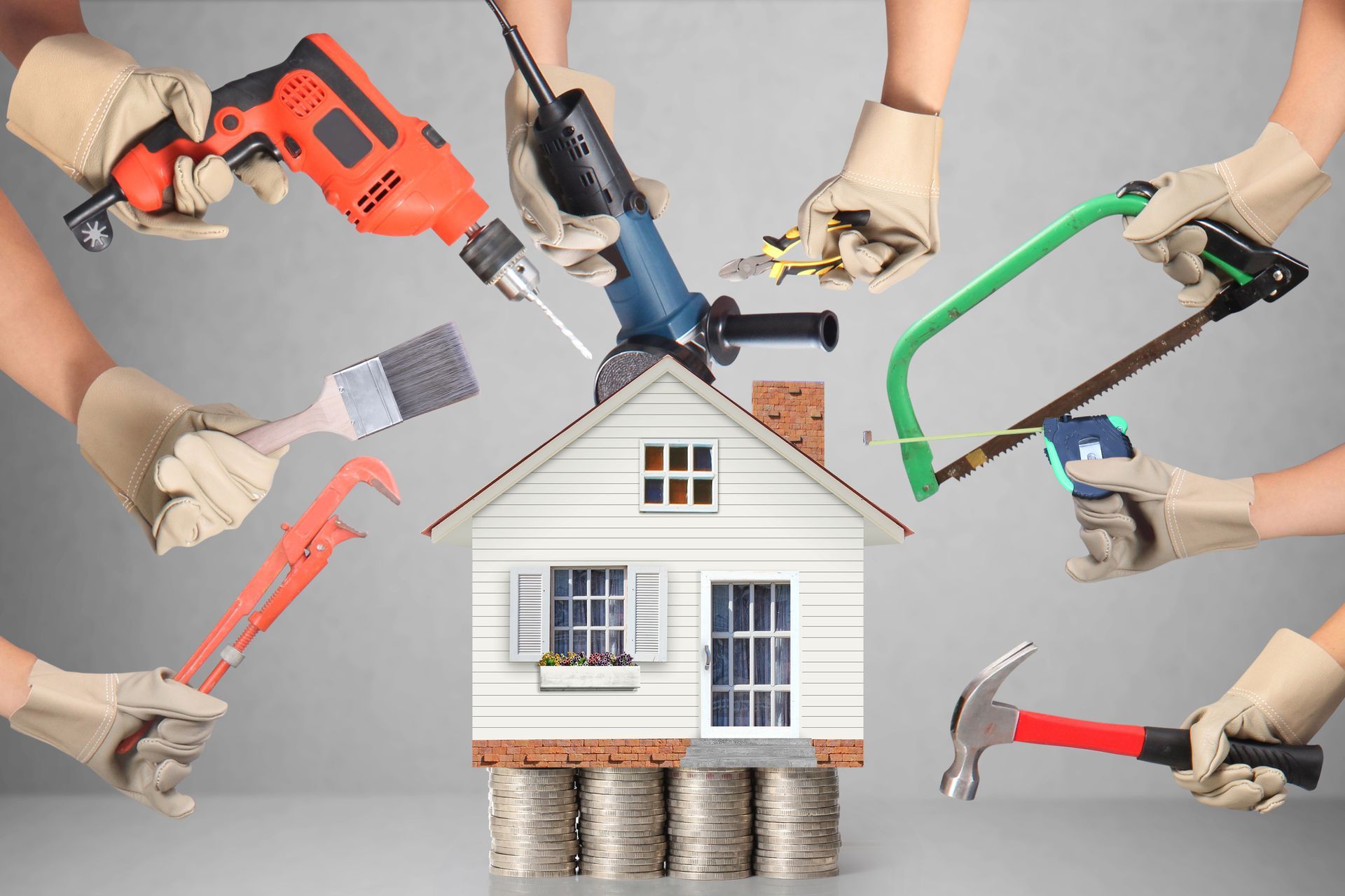 Home improvement tools surrounding a house model, representing renovation and repair services.