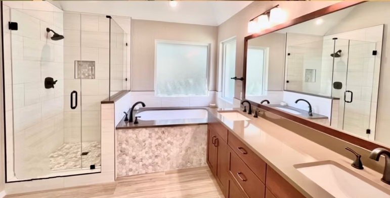 Modern bathroom with walk-in shower, soaking tub, double vanity, wood cabinets, and neutral color scheme.