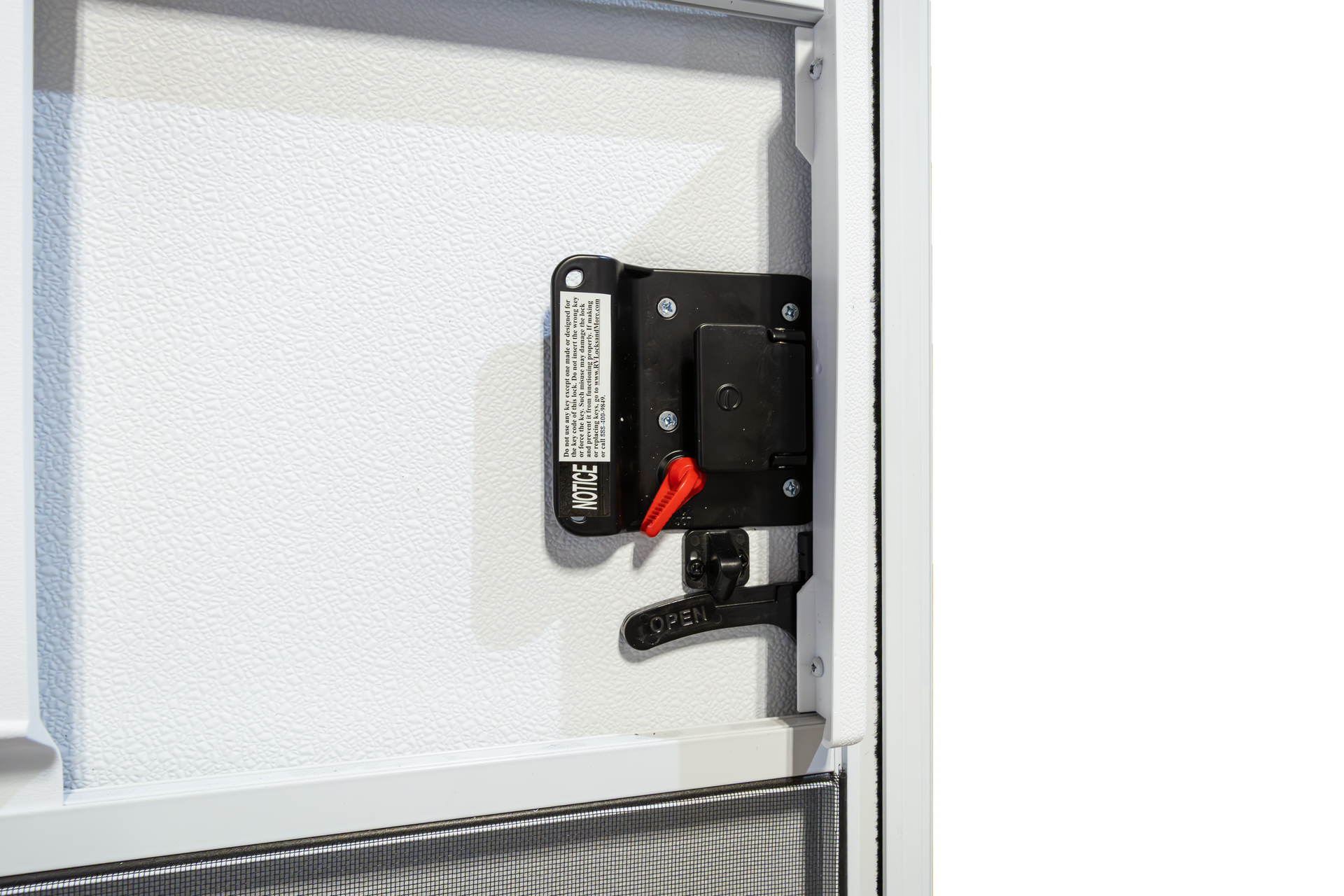 Black locking mechanism mounted on a light gray metal door frame, with a red tag attached.