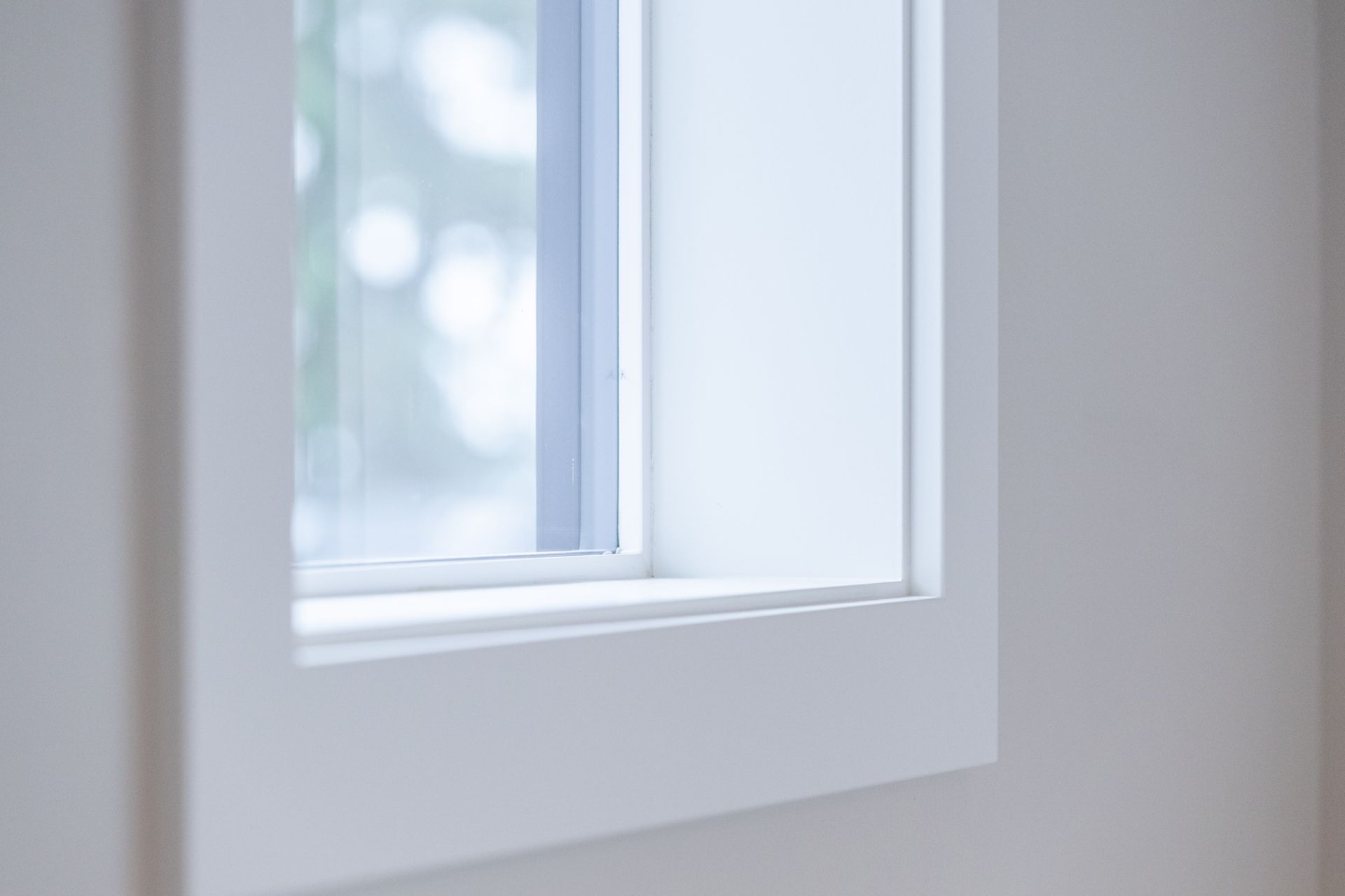 White-framed window with frosted glass letting in soft daylight