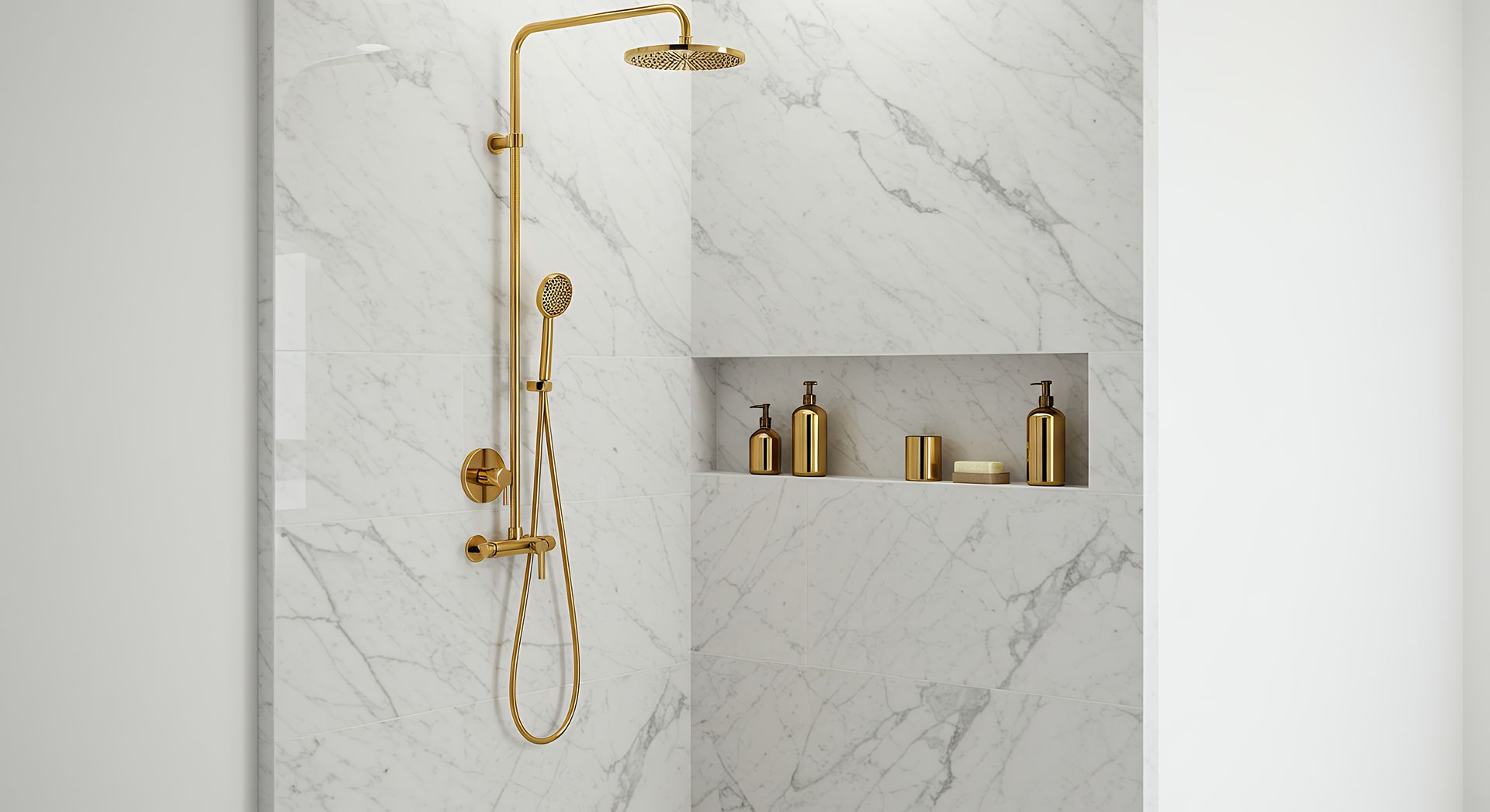 Gold shower fixture with handheld sprayer in a marble-tiled bathroom alcove with gold bottles Gold shower fixture with handheld sprayer in a marble-tiled bathroom alcove with gold bottles