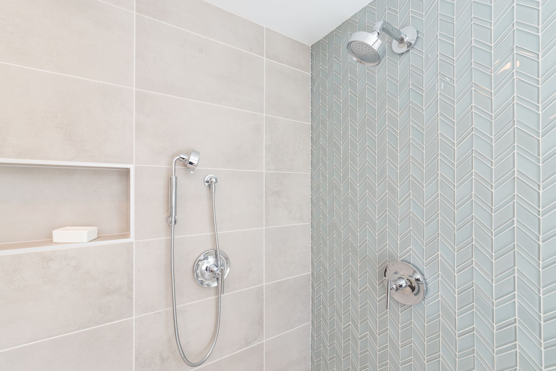 Modern bathroom shower with glass mosaic tile, wall-mounted showerhead, and handheld sprayer Modern bathroom shower with glass mosaic tile, wall-mounted showerhead, and handheld sprayer